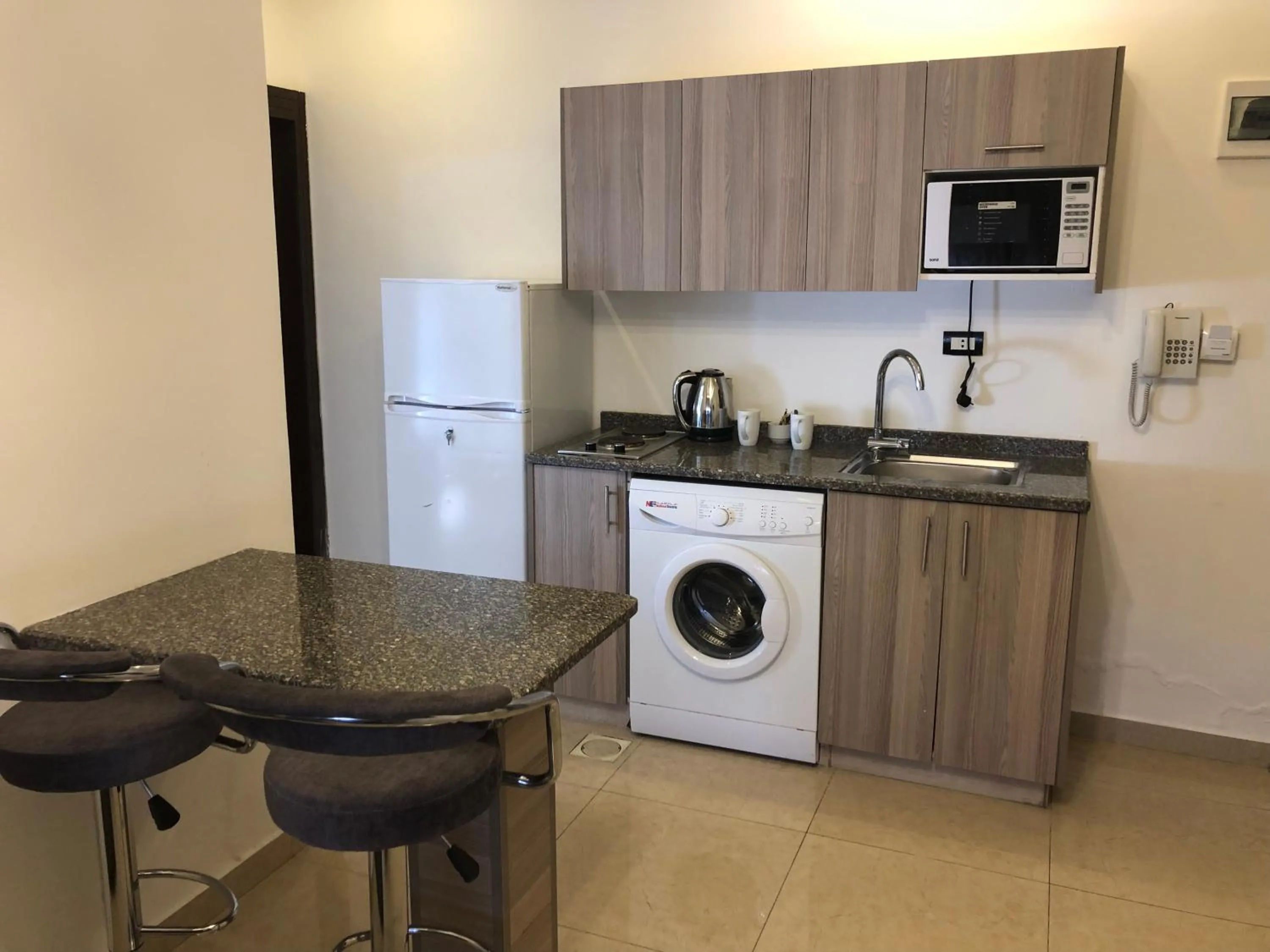 Kitchen or kitchenette in AlQimah Hotel Apartments
