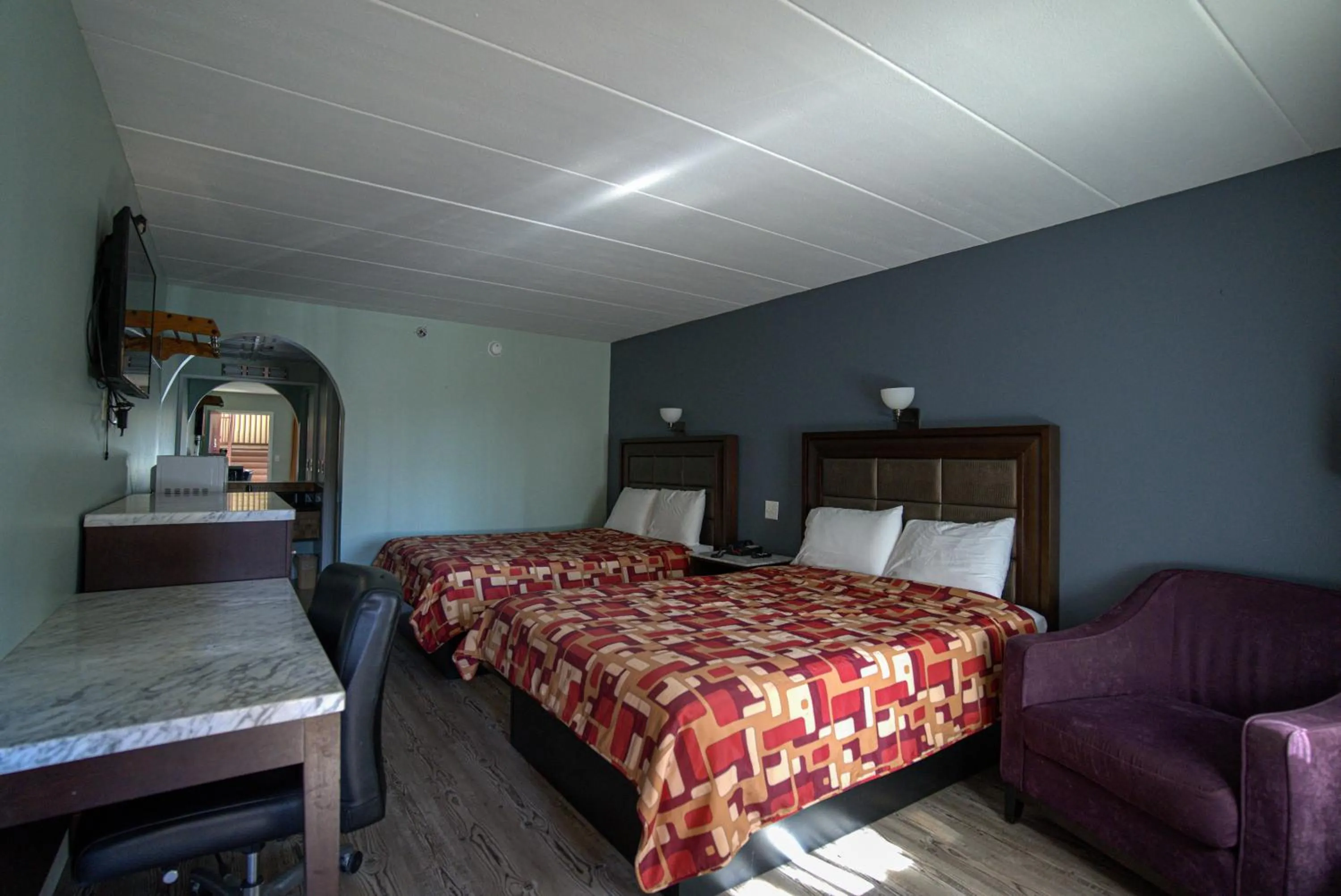 Bed in Excel Inn & Suites