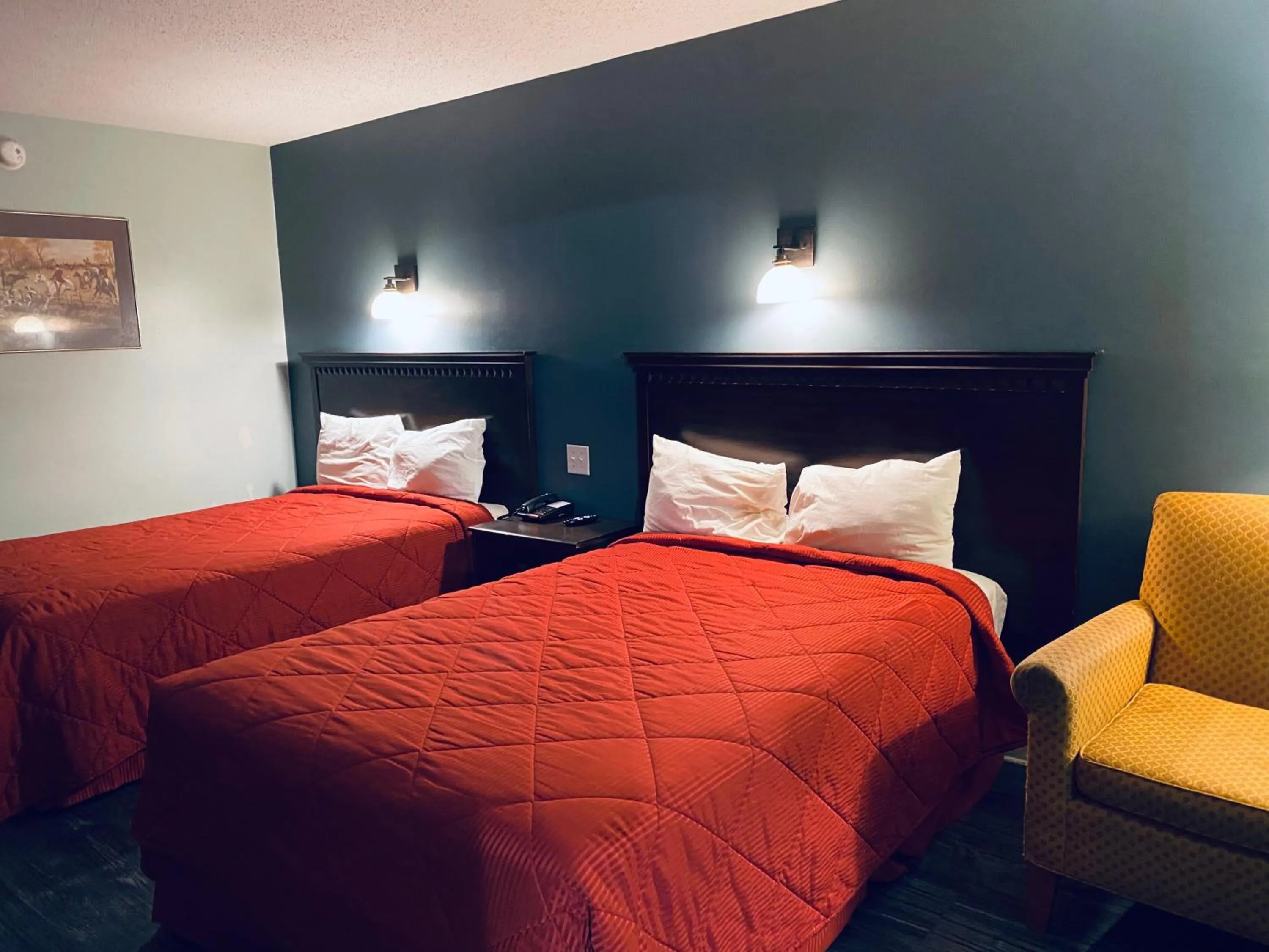 Bed in Excel Inn & Suites