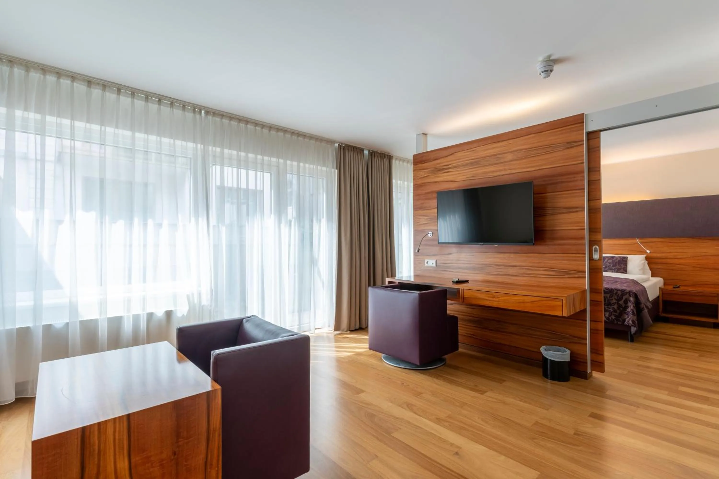 Living room, Bed in Pakat Suites