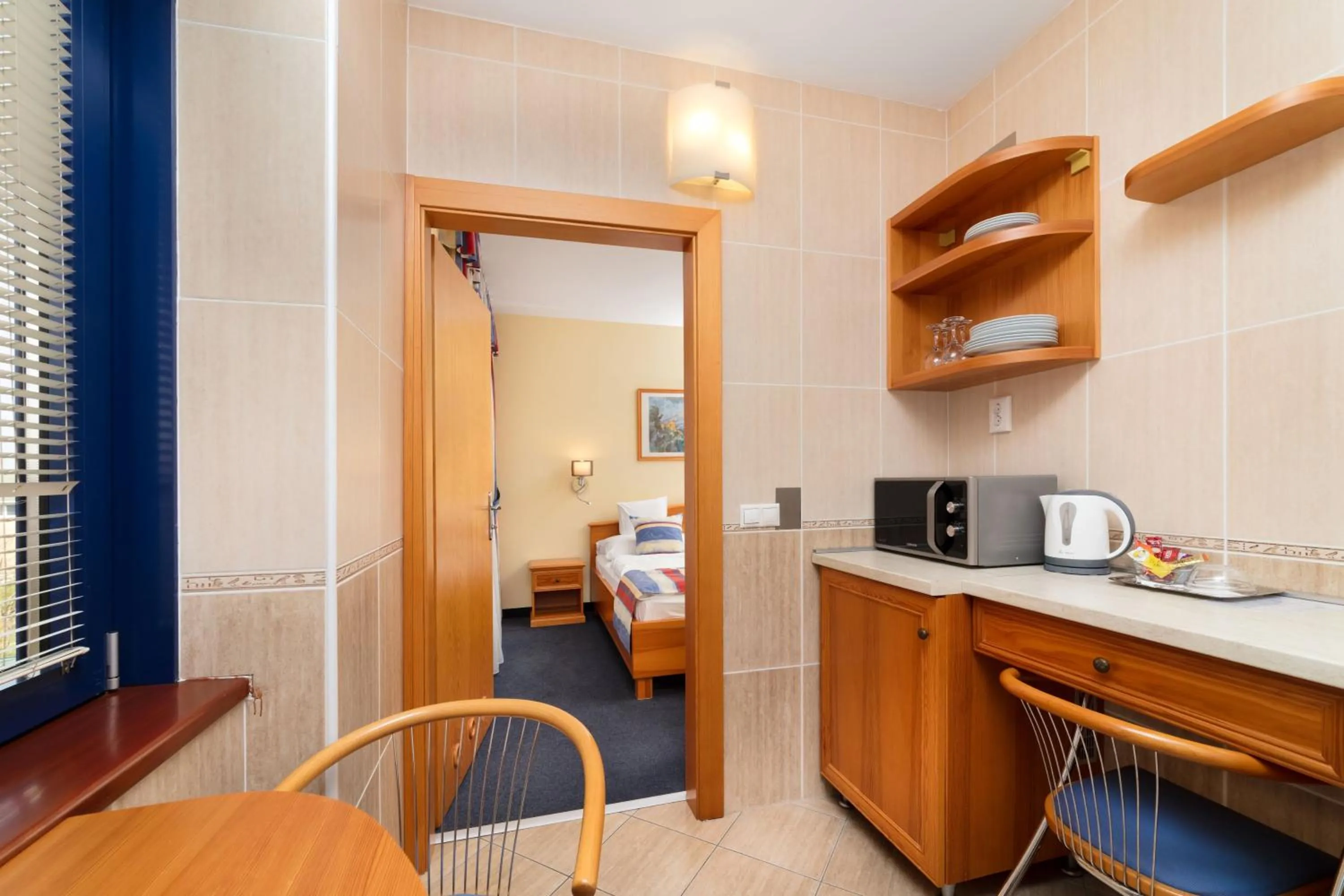 Kitchen or kitchenette, Bed in Hotel Kálvária Superior