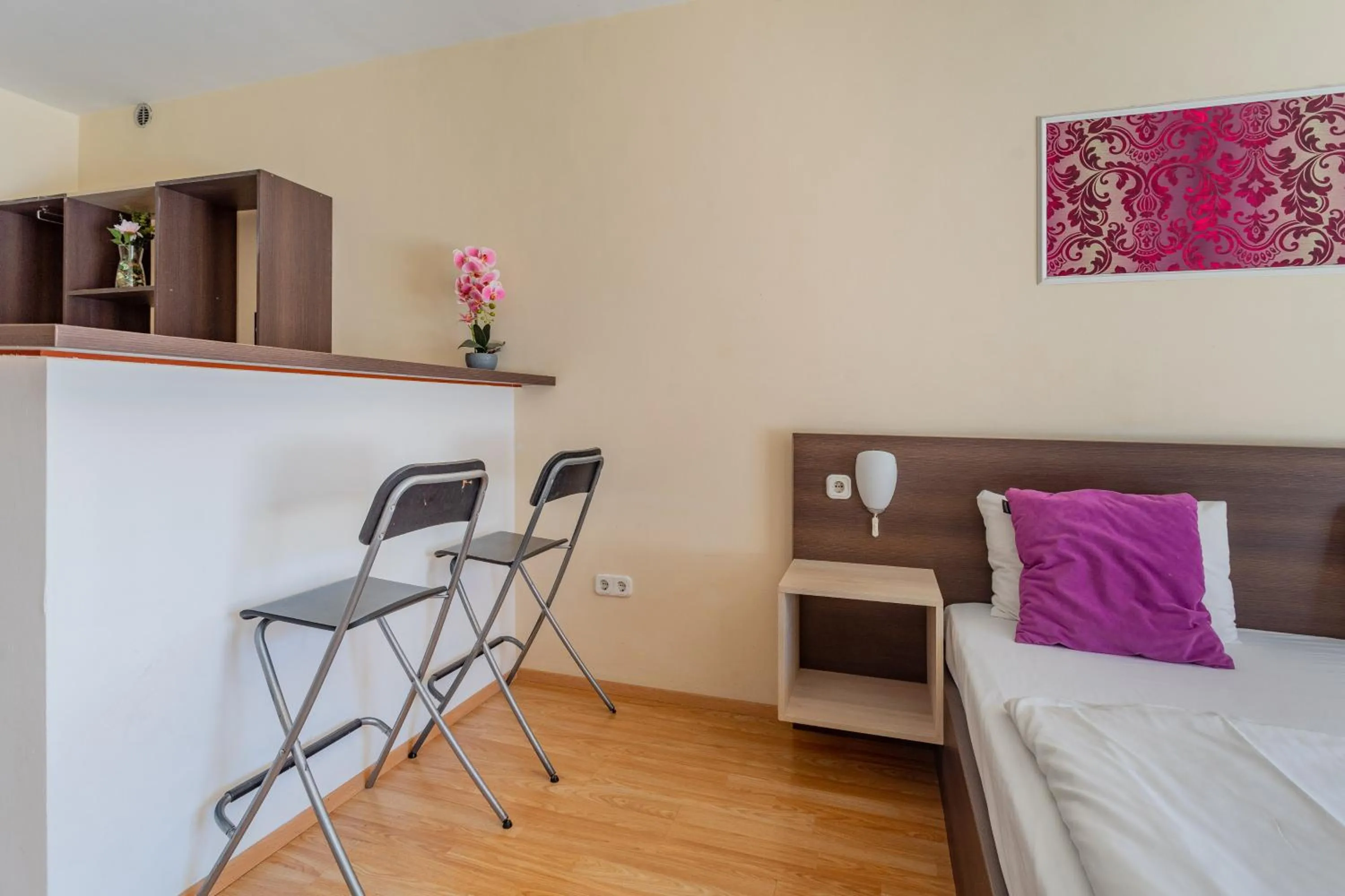 Bed in Triple M Hotel