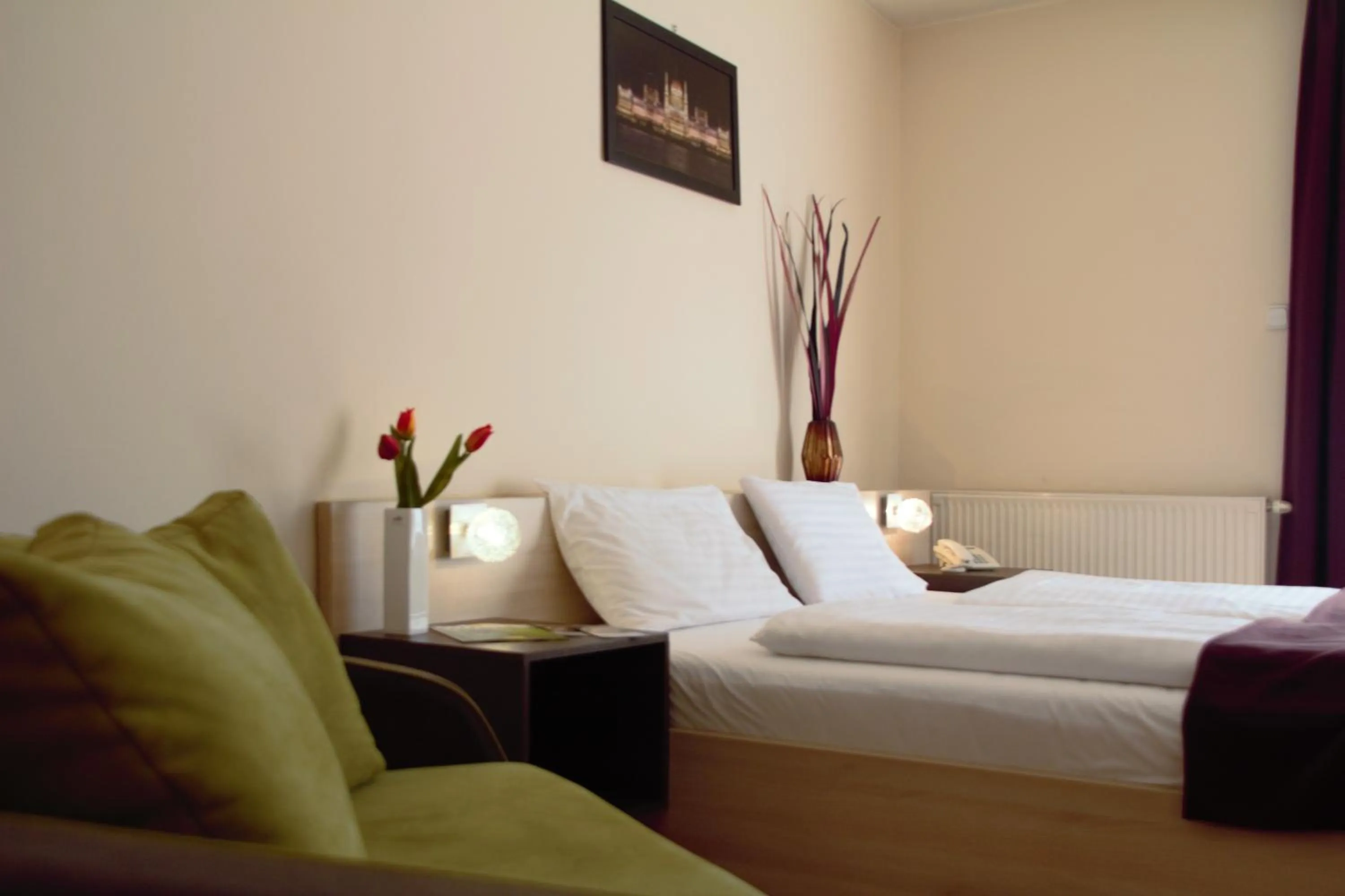 Bed in Triple M Hotel