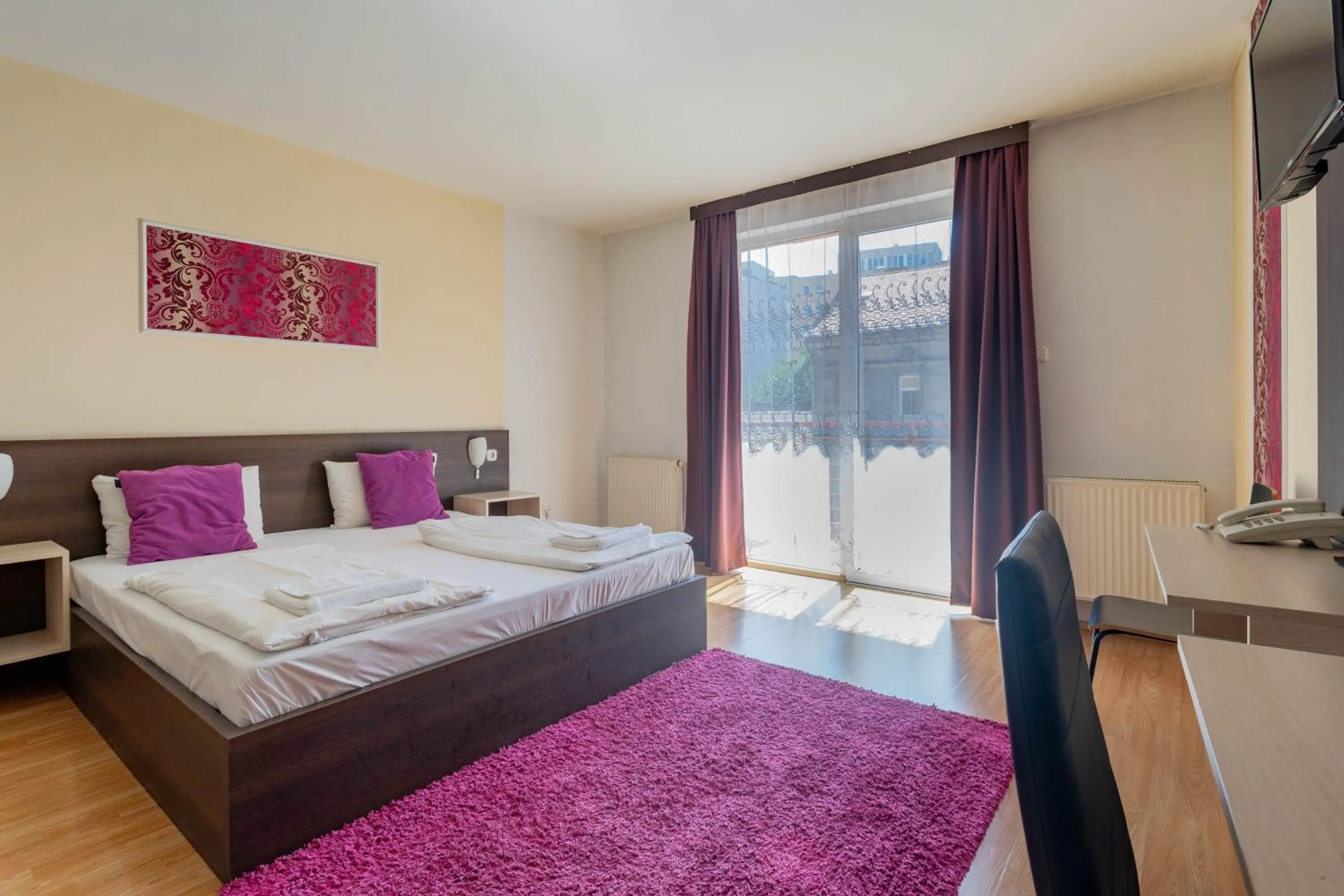 Bed in Triple M Hotel