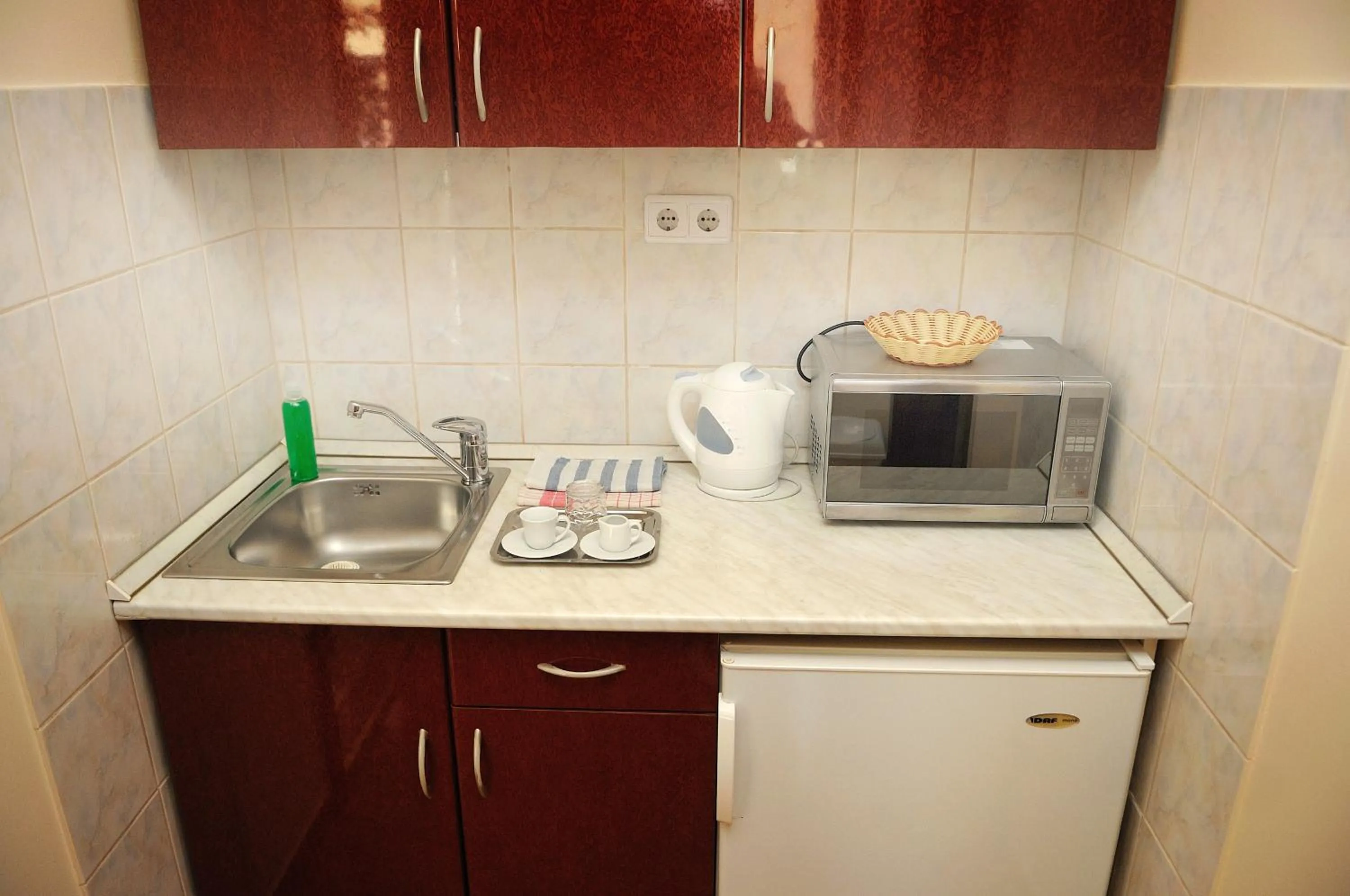 Kitchen or kitchenette in Apartman Bella Hotel