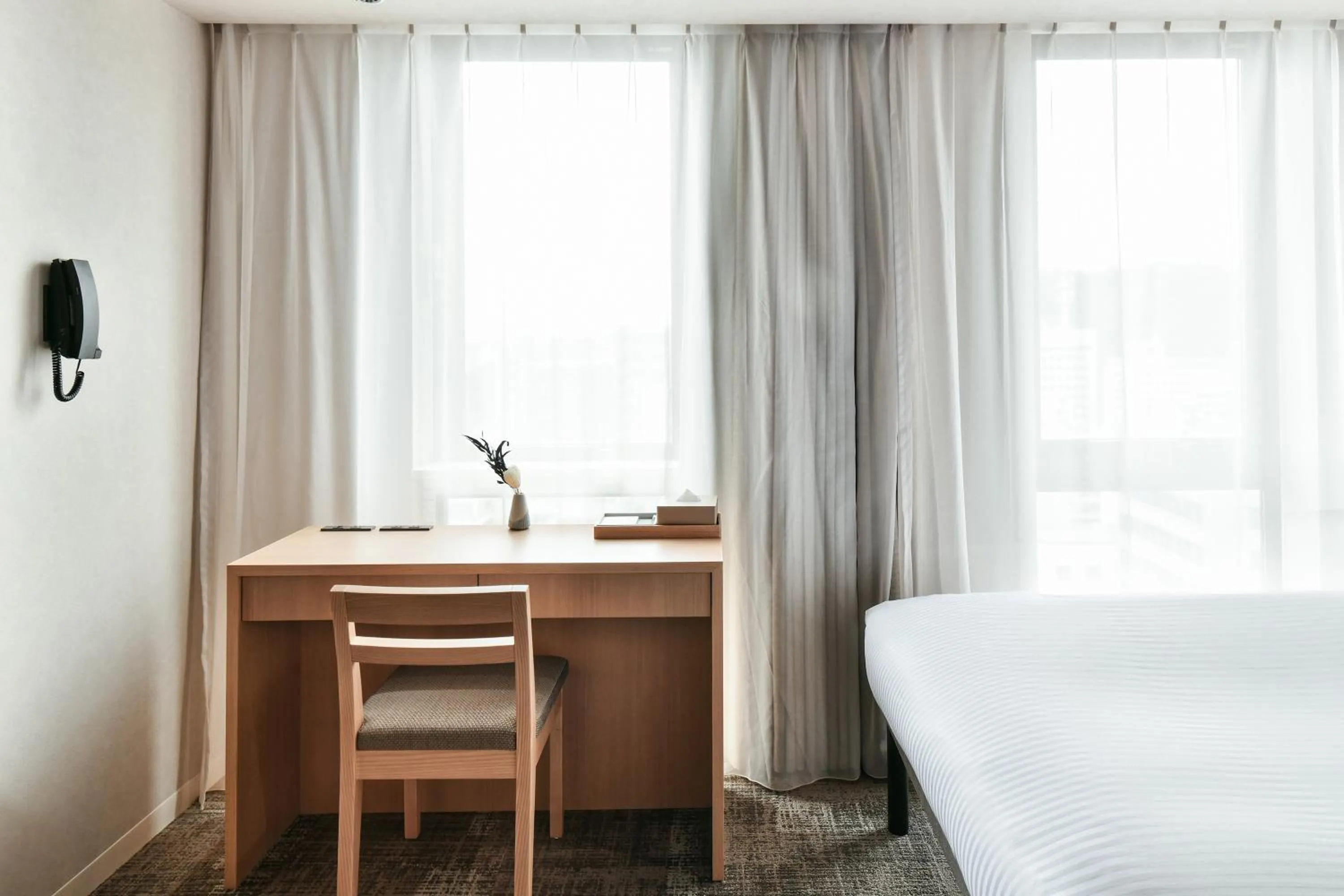 Bed in REF Matsuyama City Station by VESSEL HOTELS