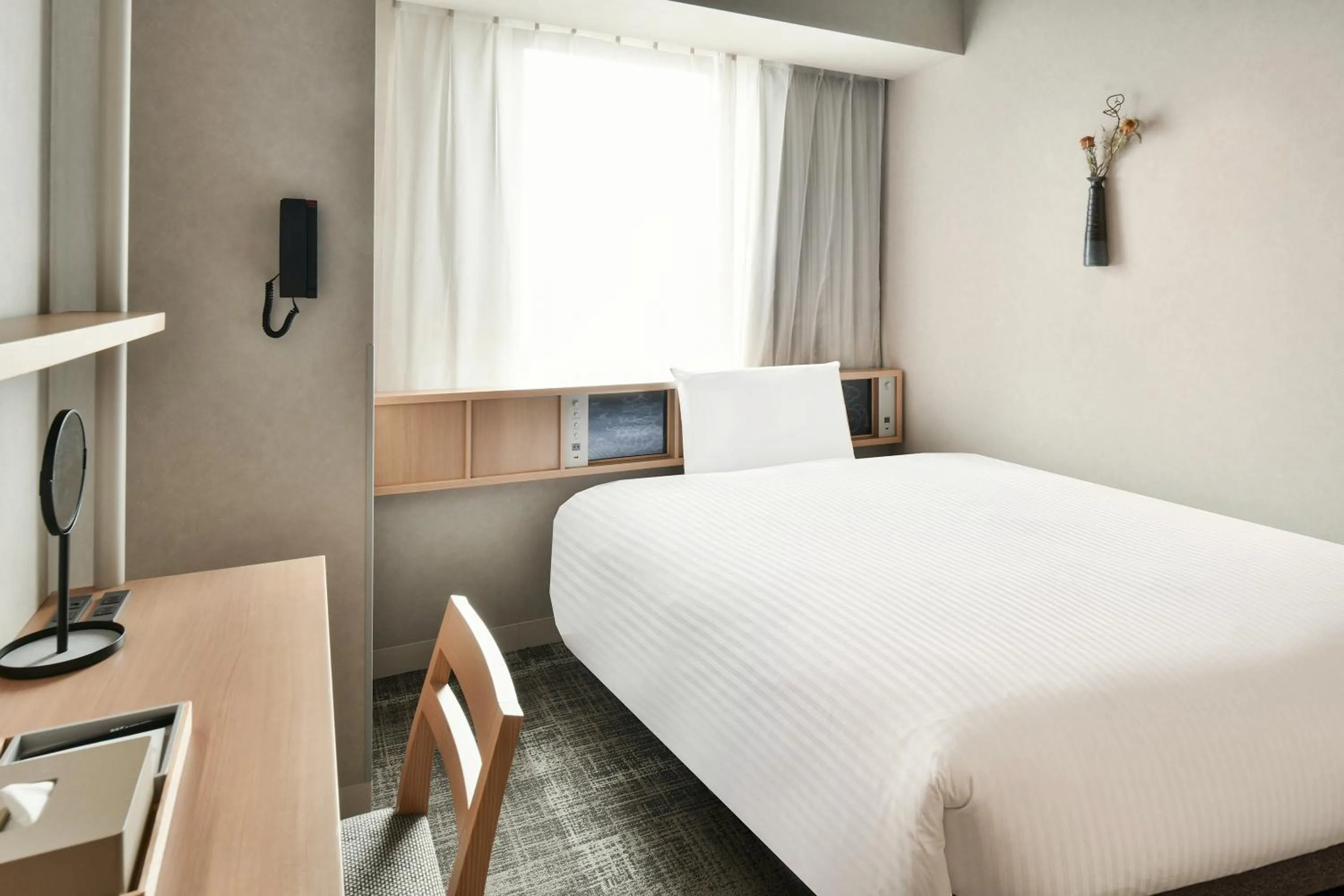 Bed in REF Matsuyama City Station by VESSEL HOTELS