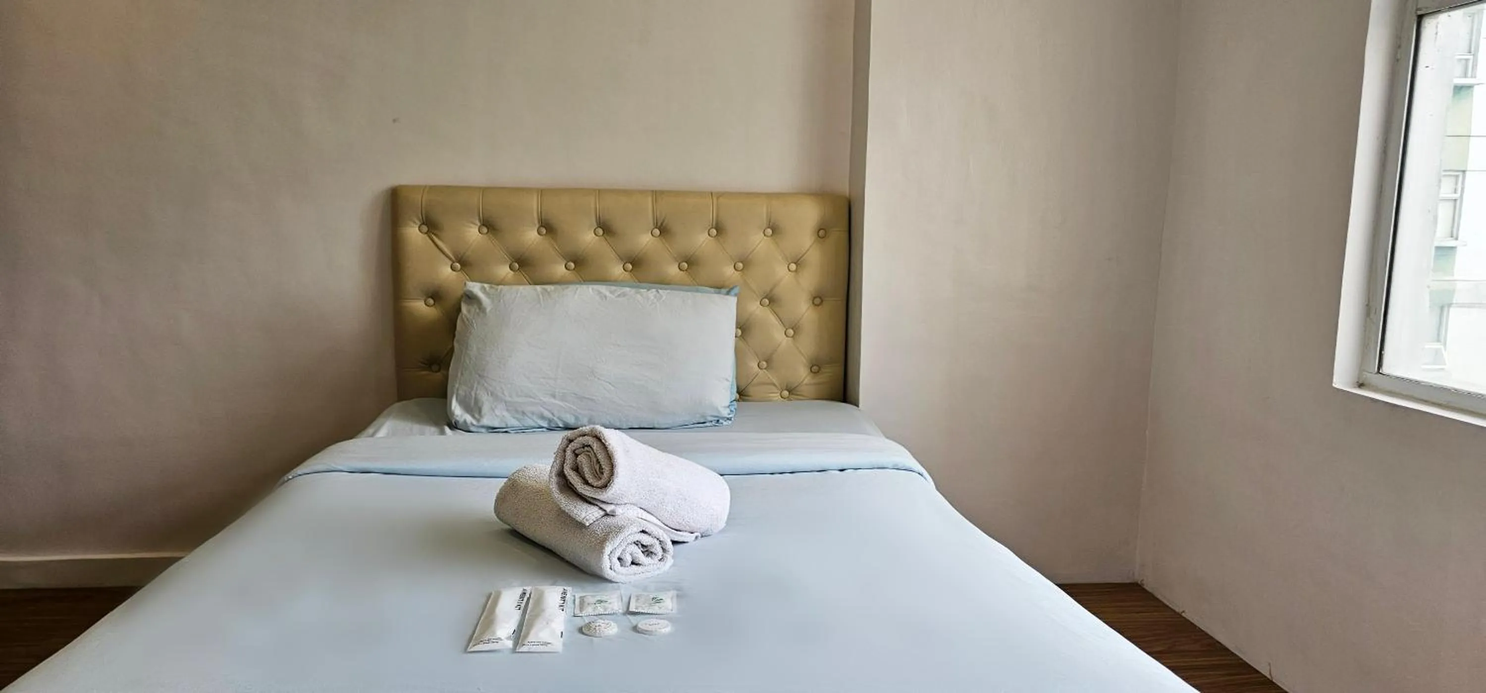 Bed in Gilmore Tower Suites By SMS Hospitality