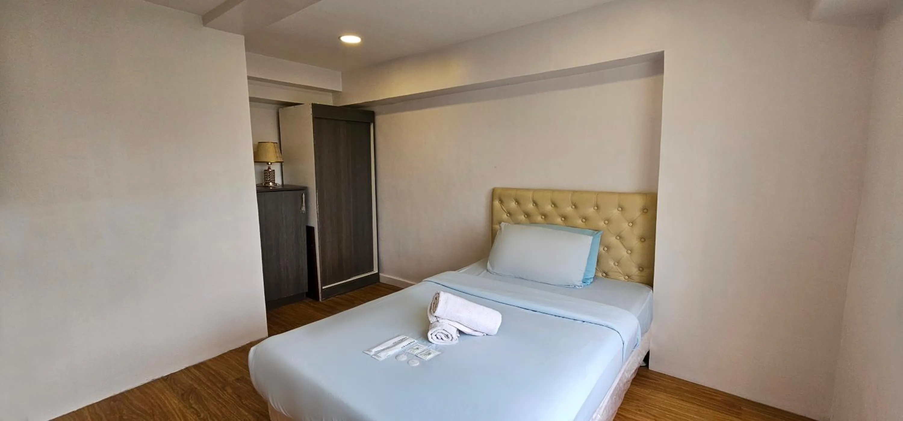 Bed in Gilmore Tower Suites By SMS Hospitality