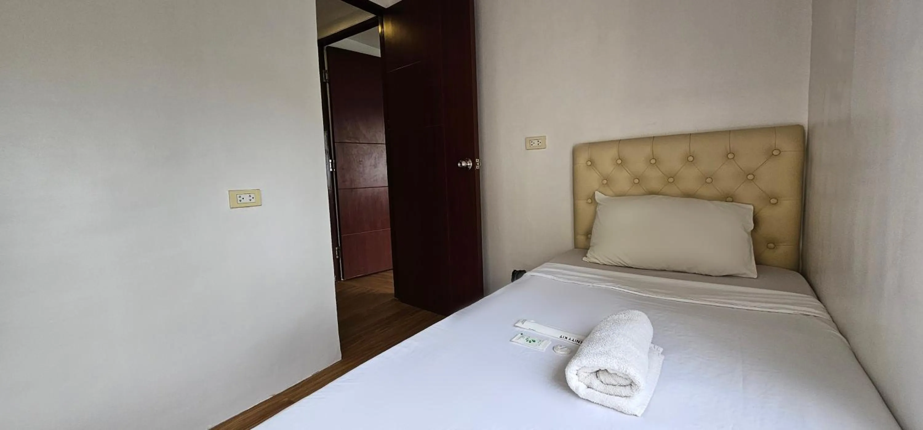 Bed in Gilmore Tower Suites By SMS Hospitality