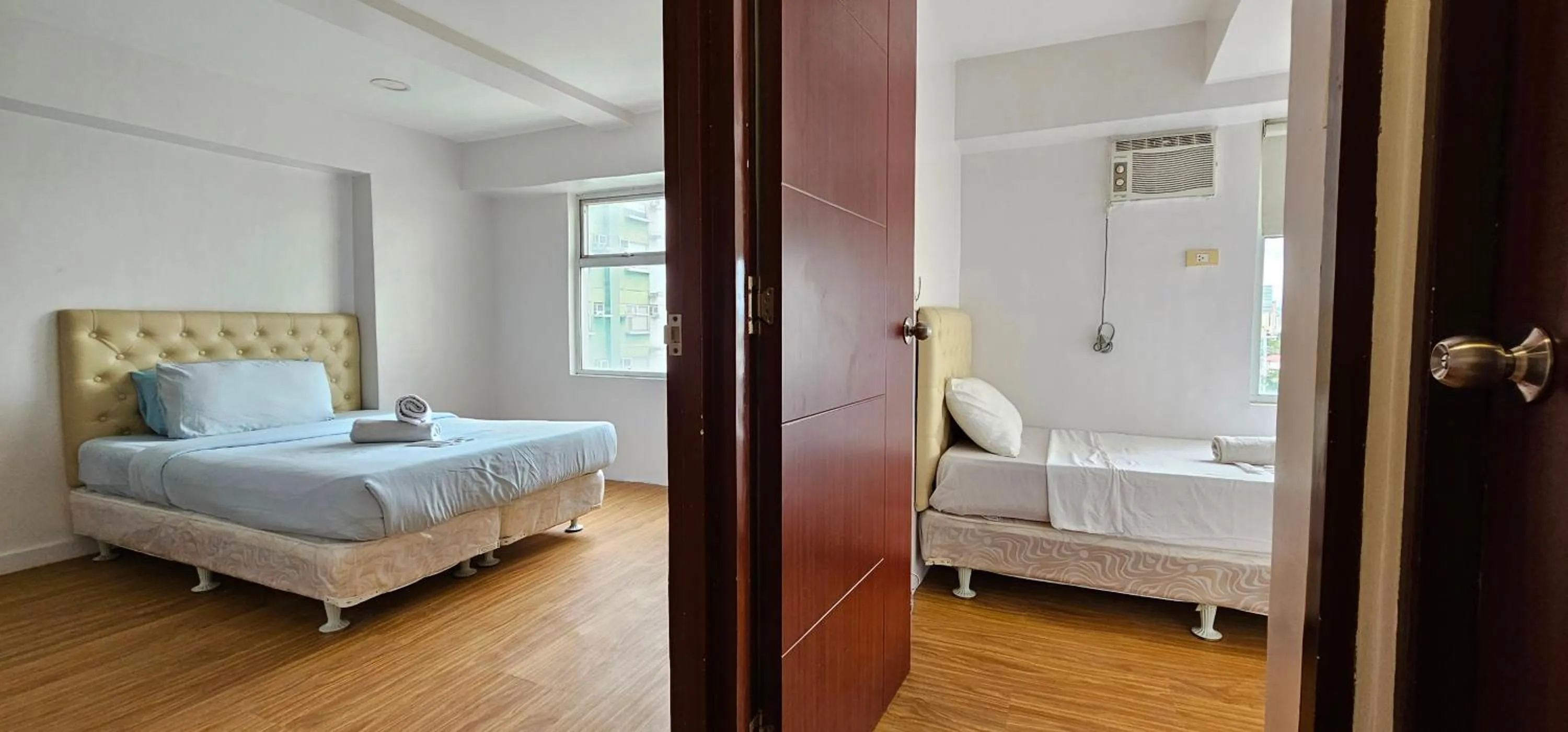 Bed in Gilmore Tower Suites By SMS Hospitality