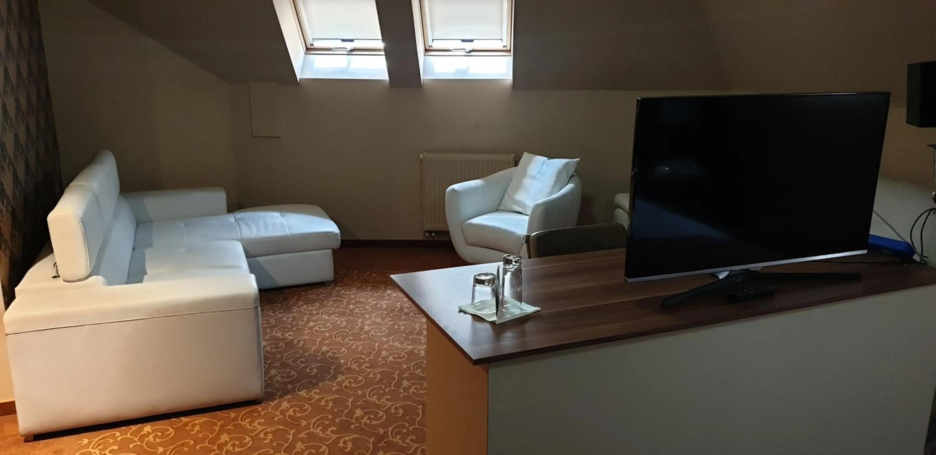 Communal lounge/ TV room in Hotel Capitulum