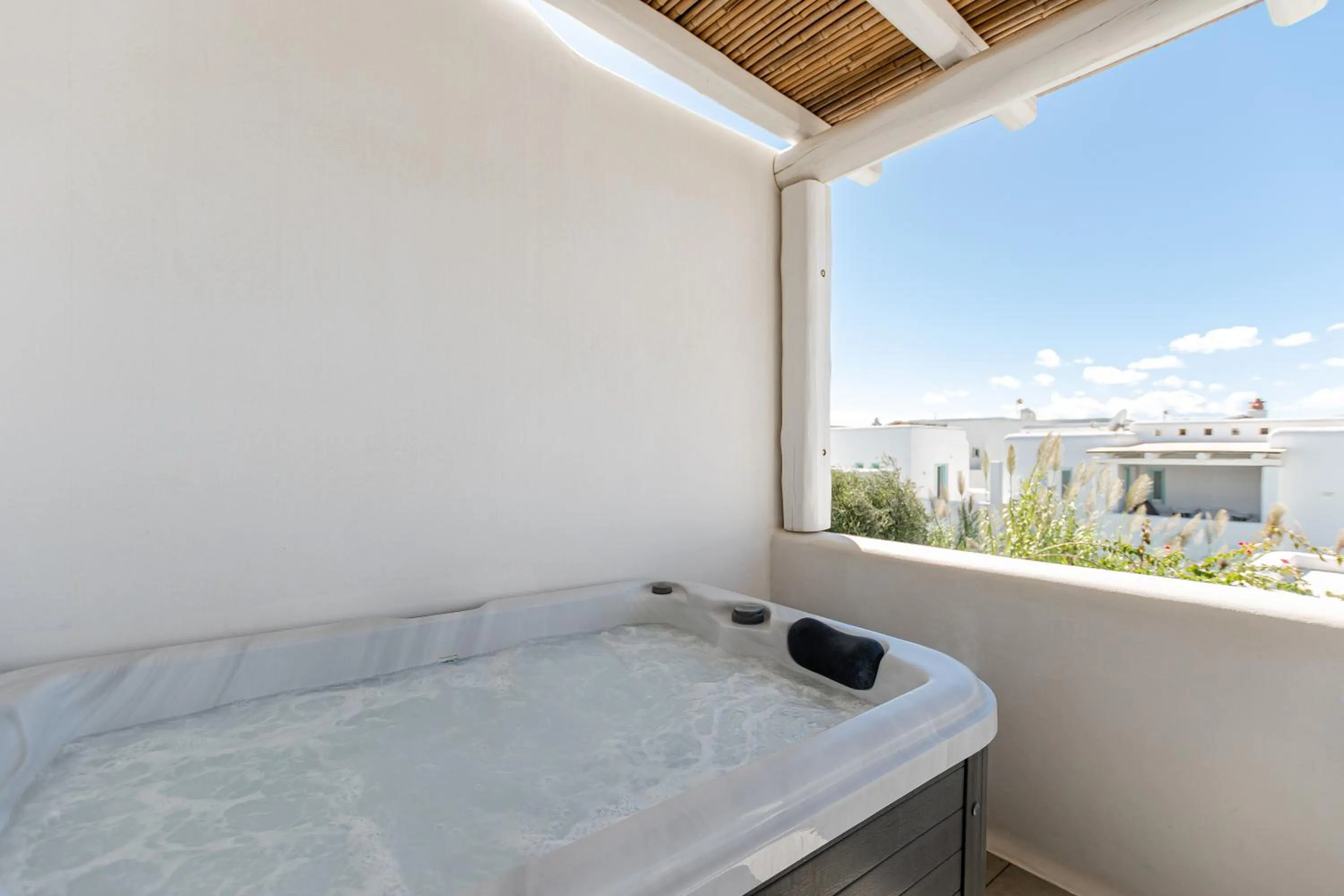 Patio, Bed in Majo Suites Hotel