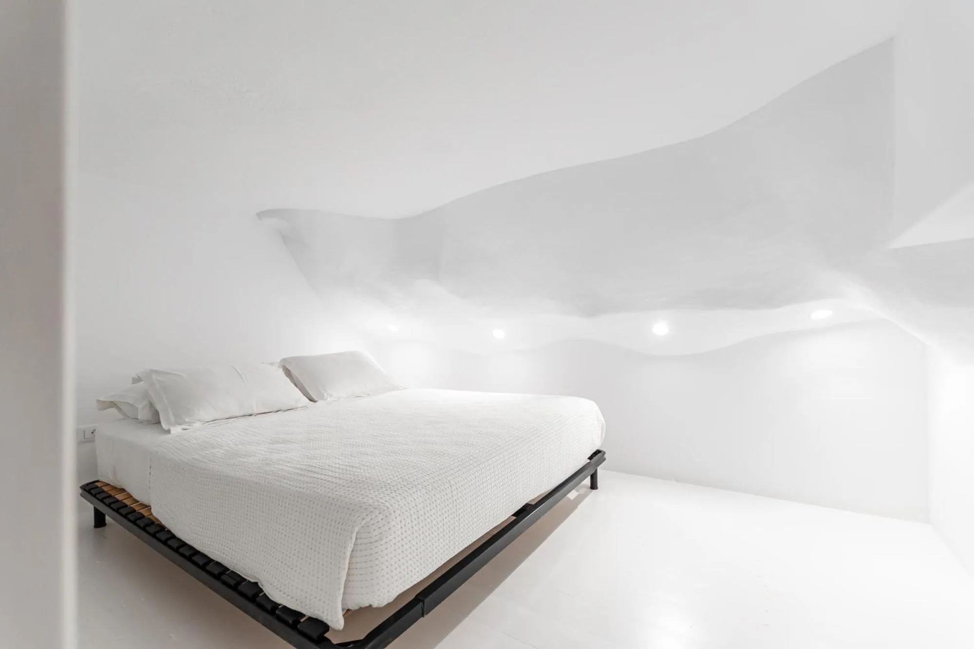 Bed in Majo Suites Hotel