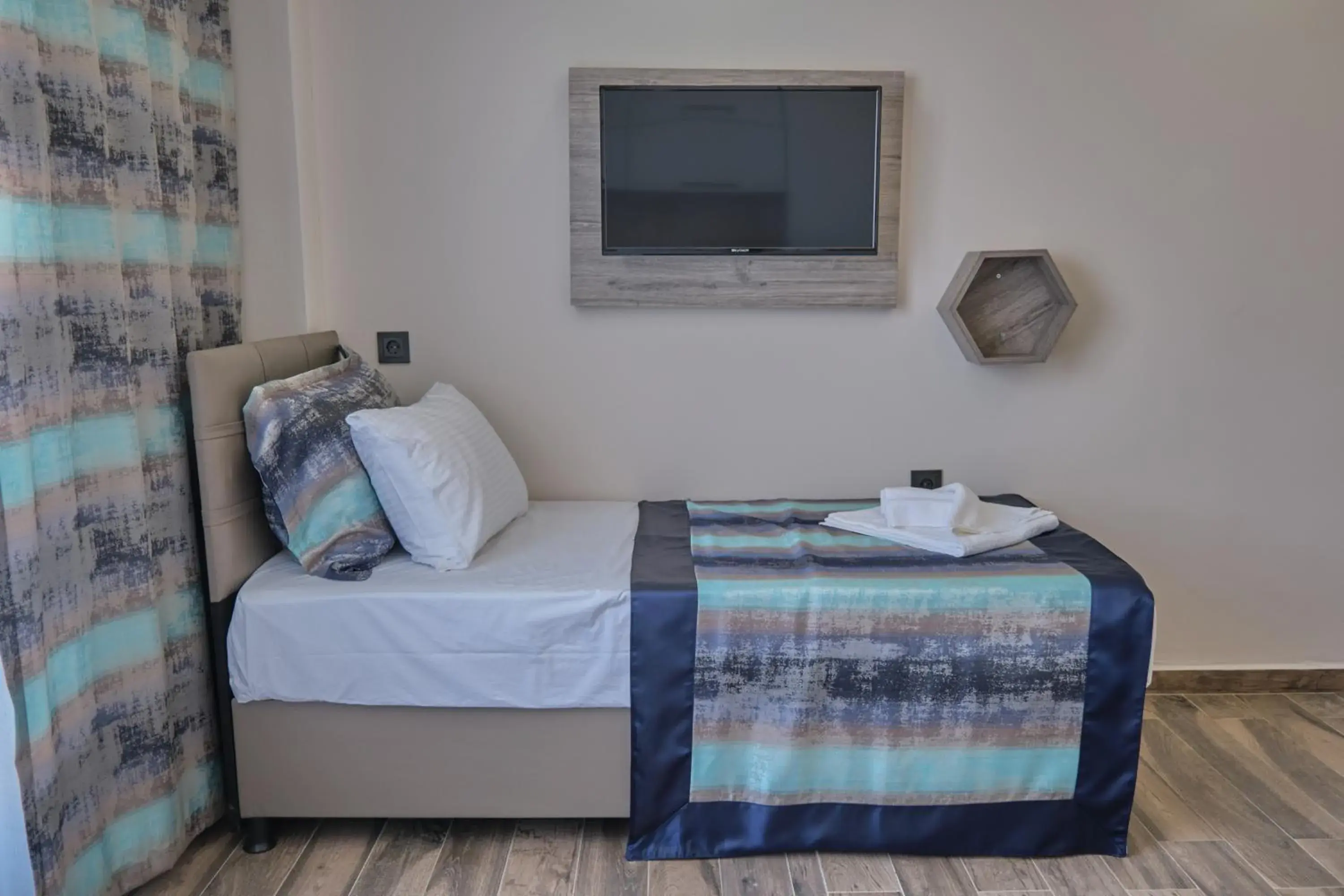 Communal lounge/ TV room, Bed in KALİSPERA HOTEL Communal lounge/ TV room, Bed in KALİSPERA HOTEL