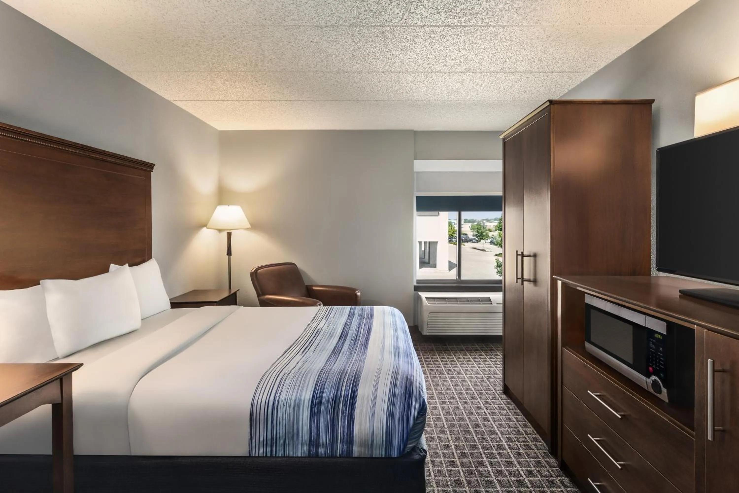 Bed in AmericInn by Wyndham Madison West