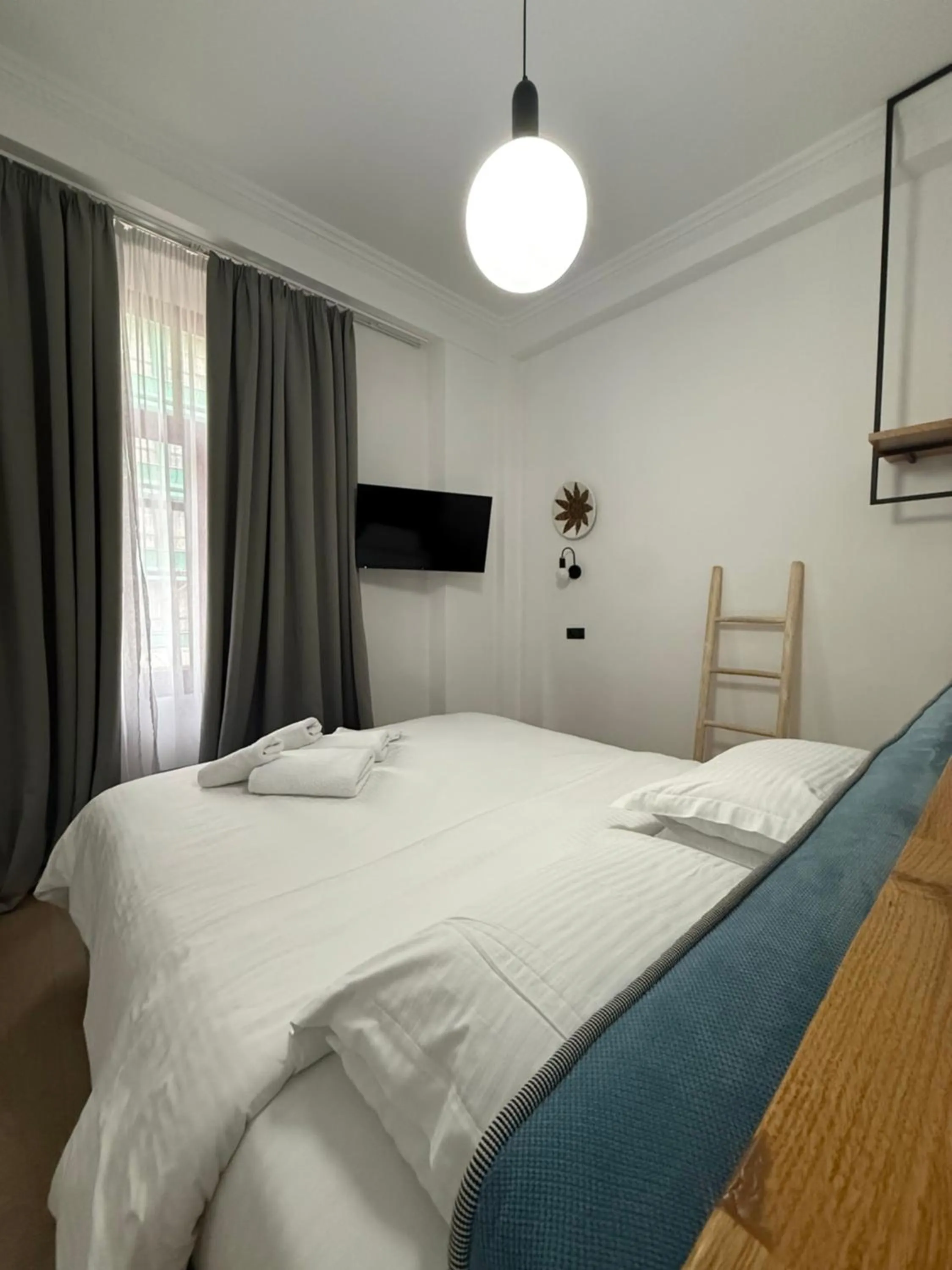 Bed in The Maroon Bottle Luxury Suites