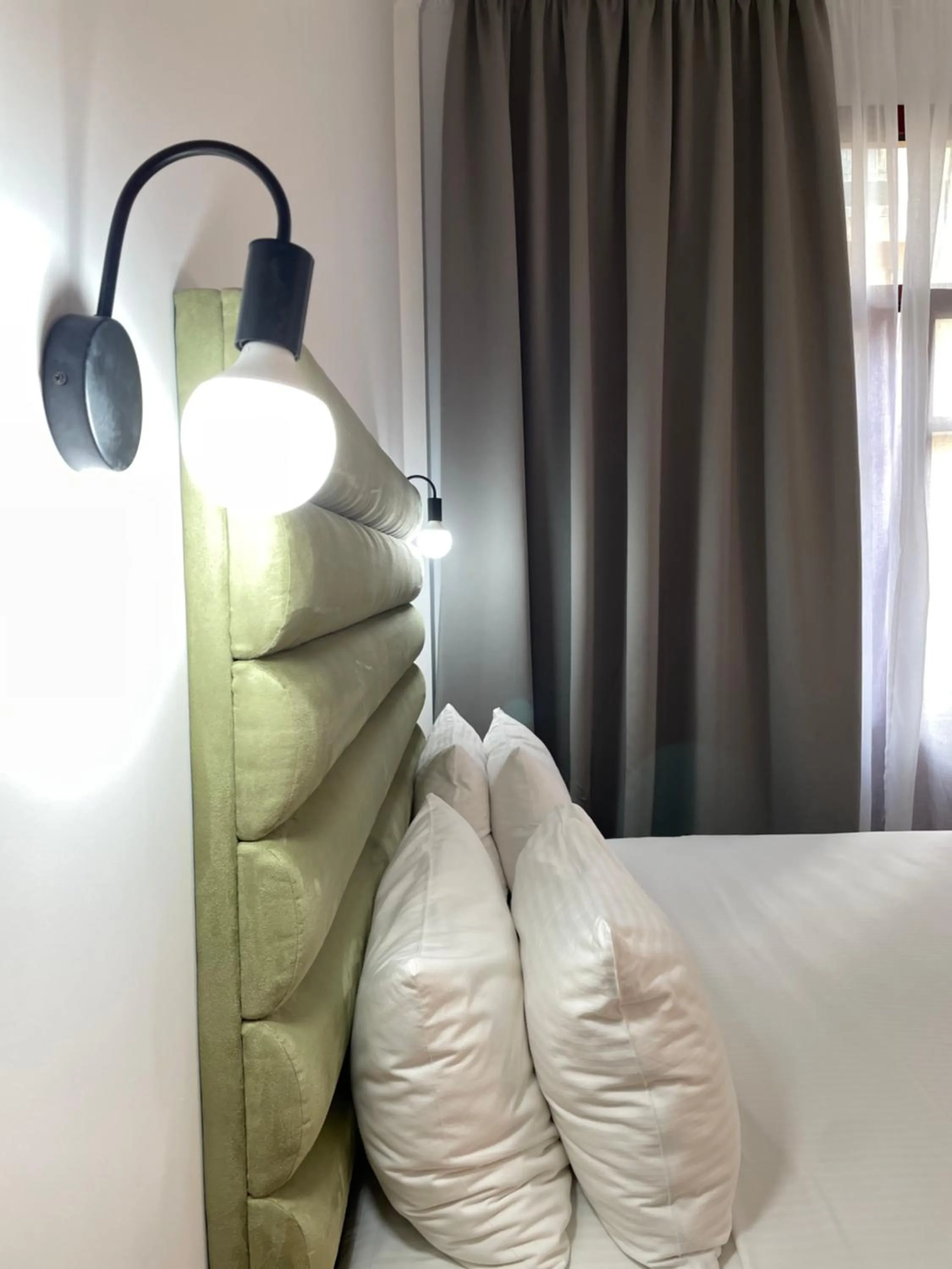 Bed in The Maroon Bottle Luxury Suites