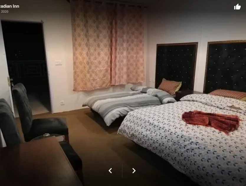 Bed in Arcadian Inn Hotel