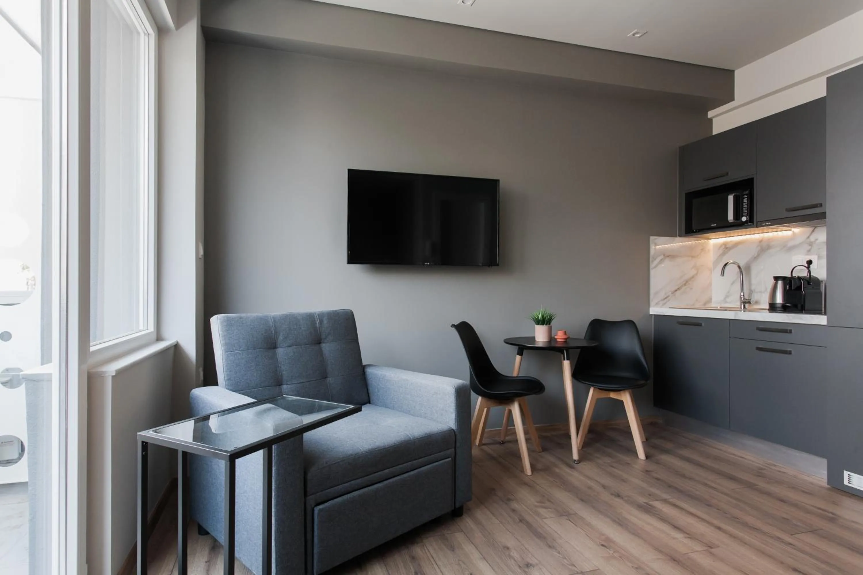 Seating area in WYZ Athens Apartments by UPSTREET