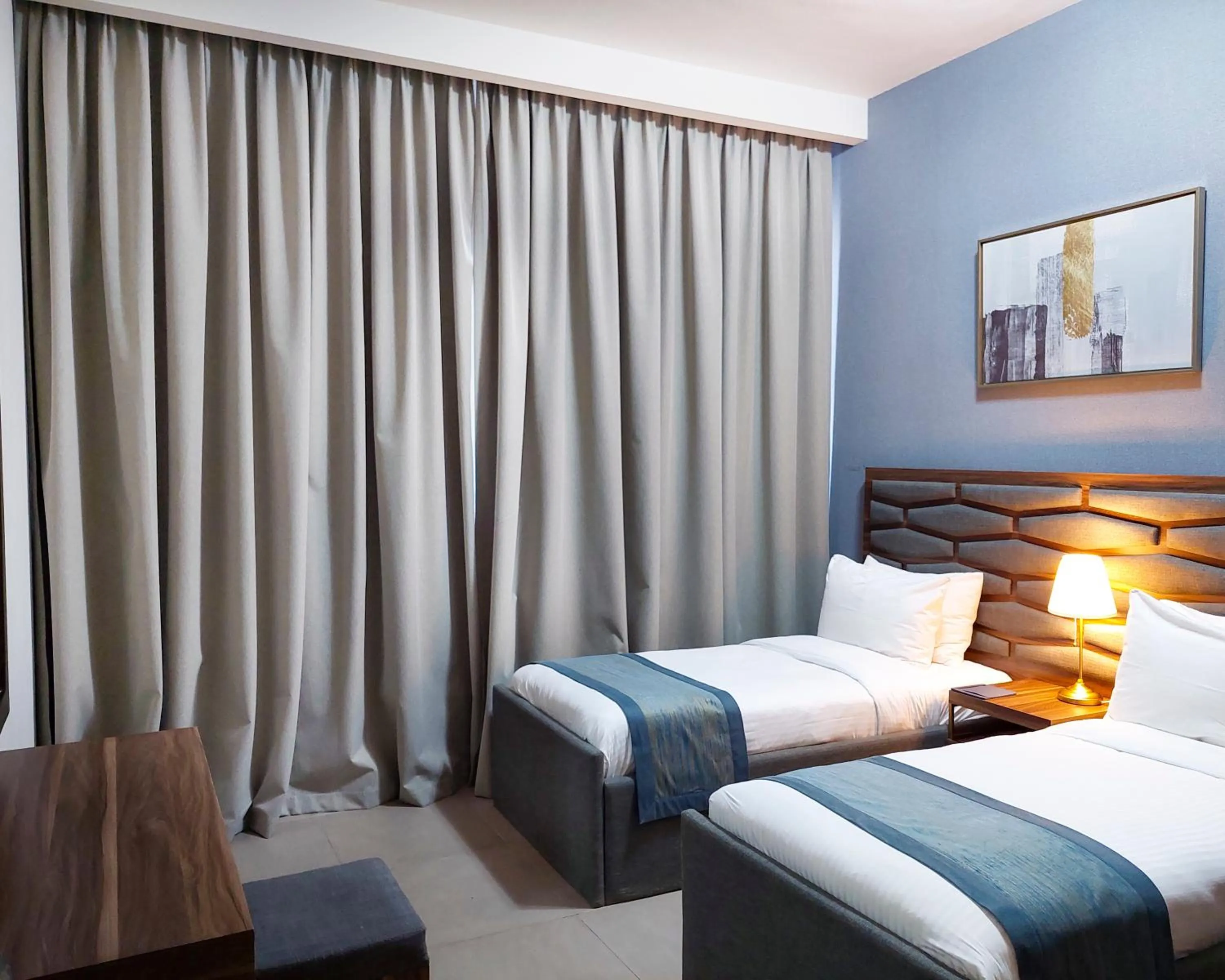 Bed in Luxe Grand Hotel Apartments