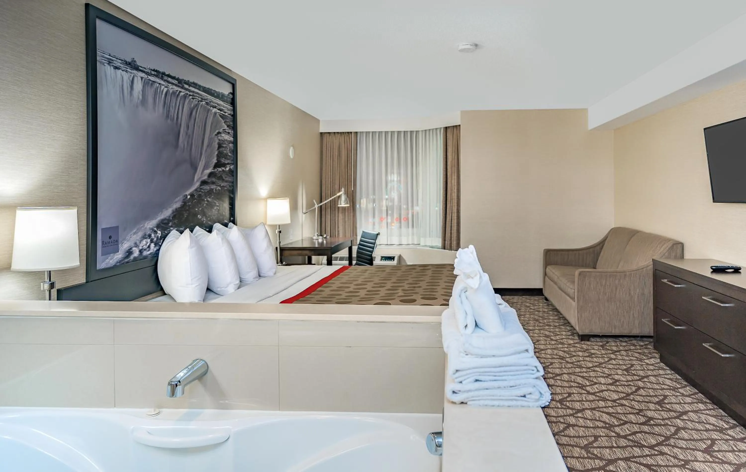 Photo of the whole room, Bed in Ramada By Wyndham Niagara Falls near the Falls