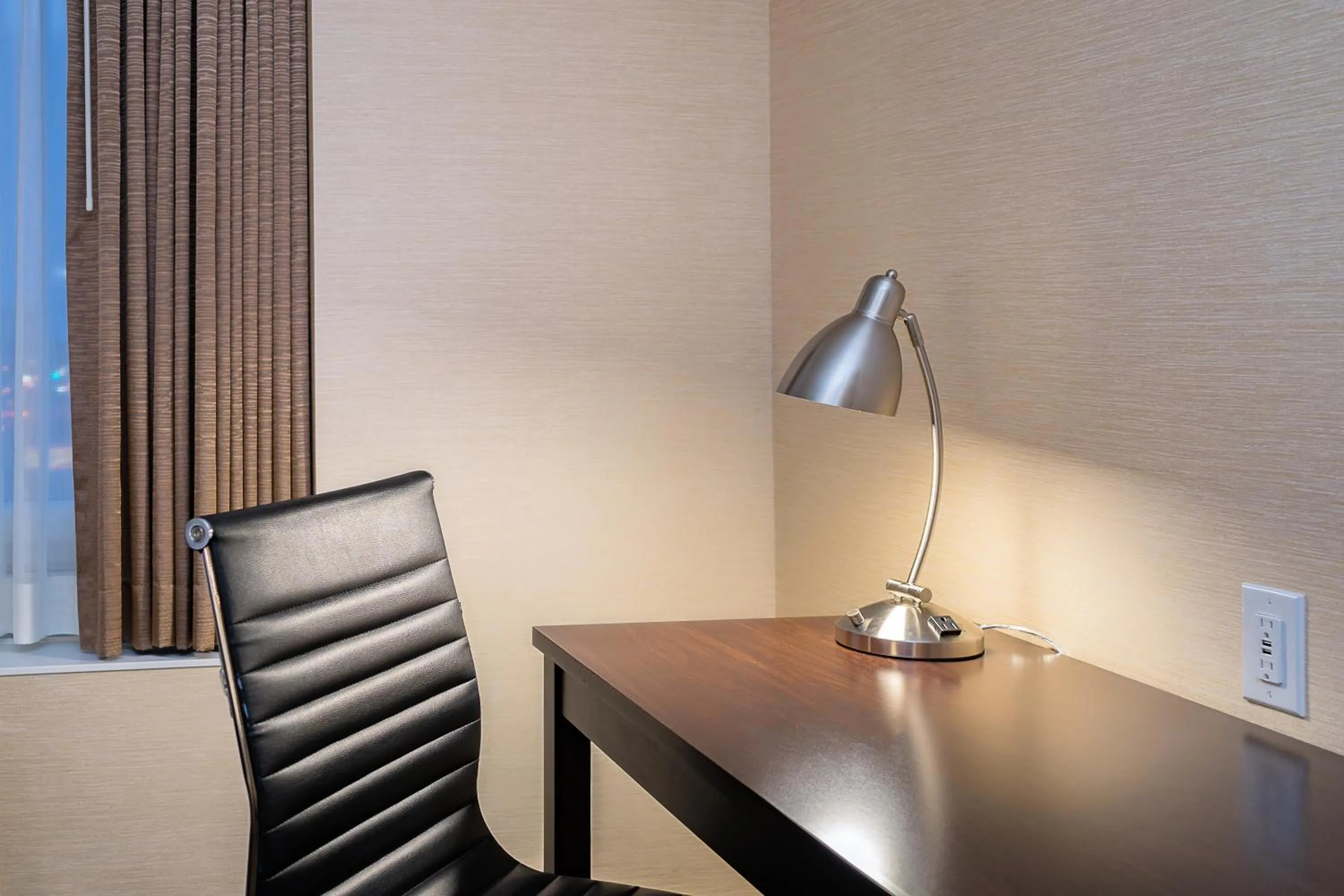 Seating area in Ramada By Wyndham Niagara Falls near the Falls