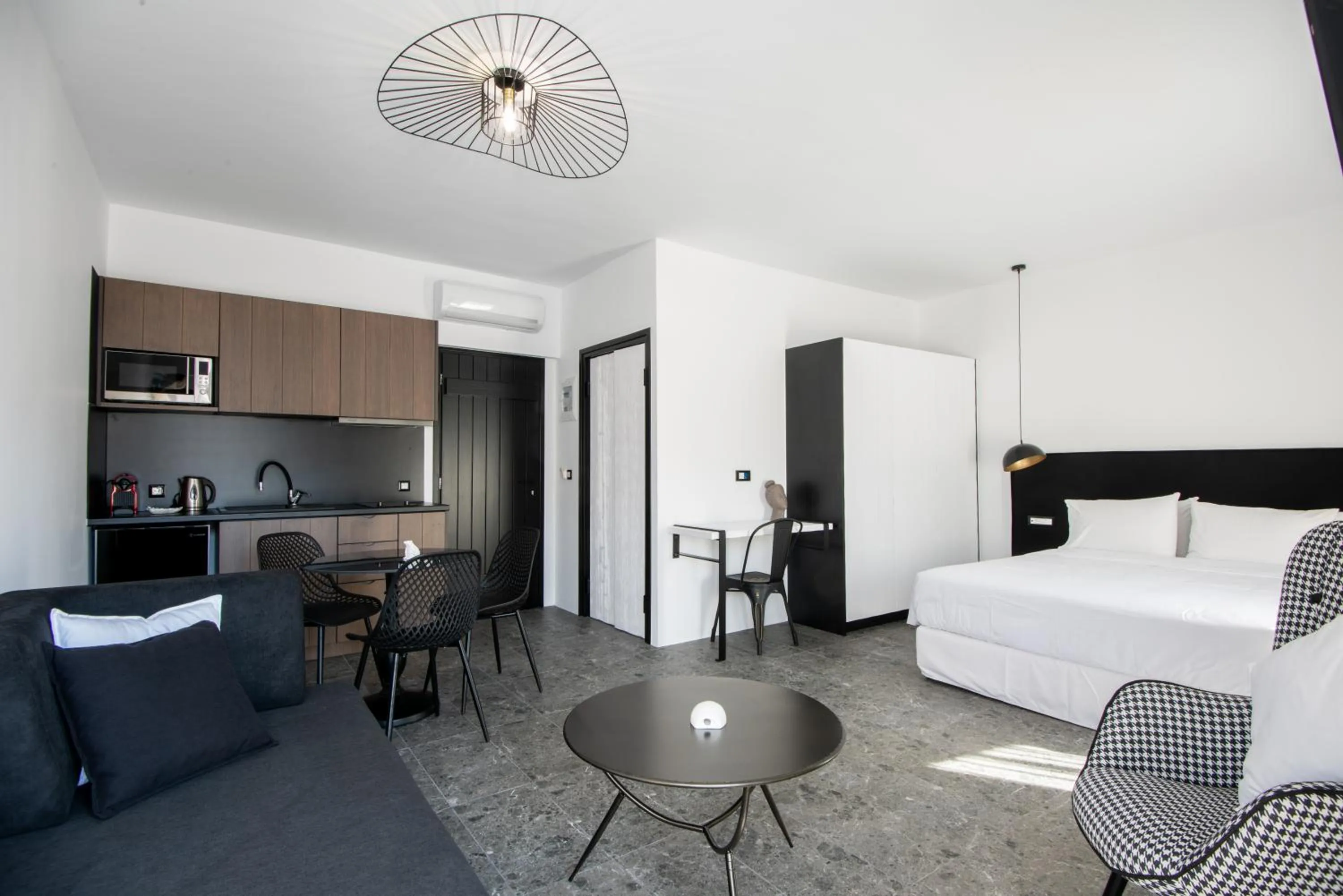 Kitchen or kitchenette, Bed in Kalypso Suites Hotel - Adults Only