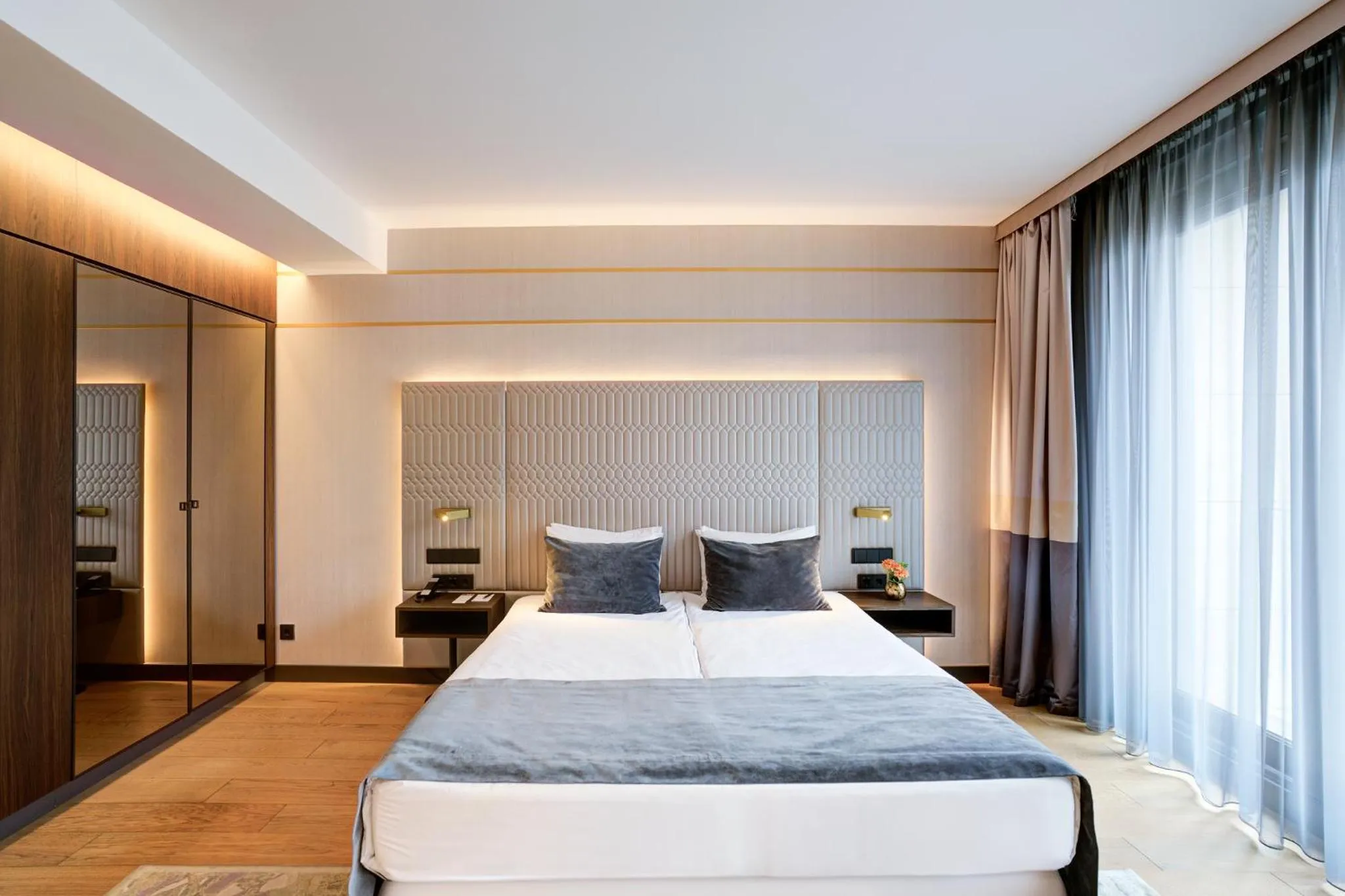 Bed in Emerald Downtown Luxury Suites by Continental Group