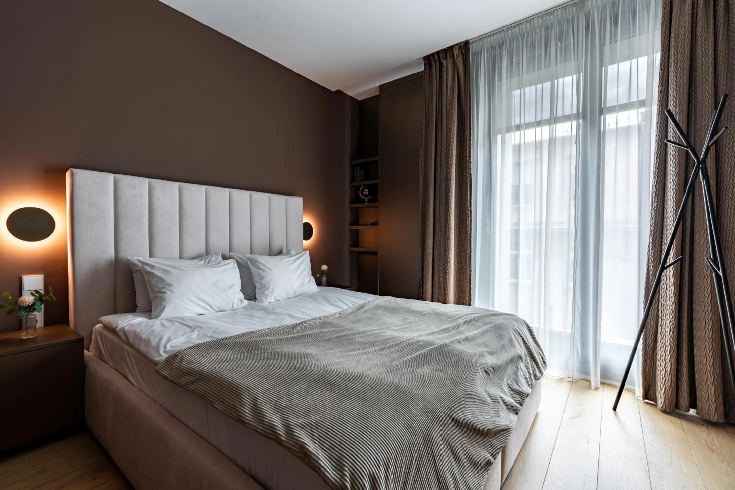 Bed in Emerald Downtown Luxury Suites by Continental Group