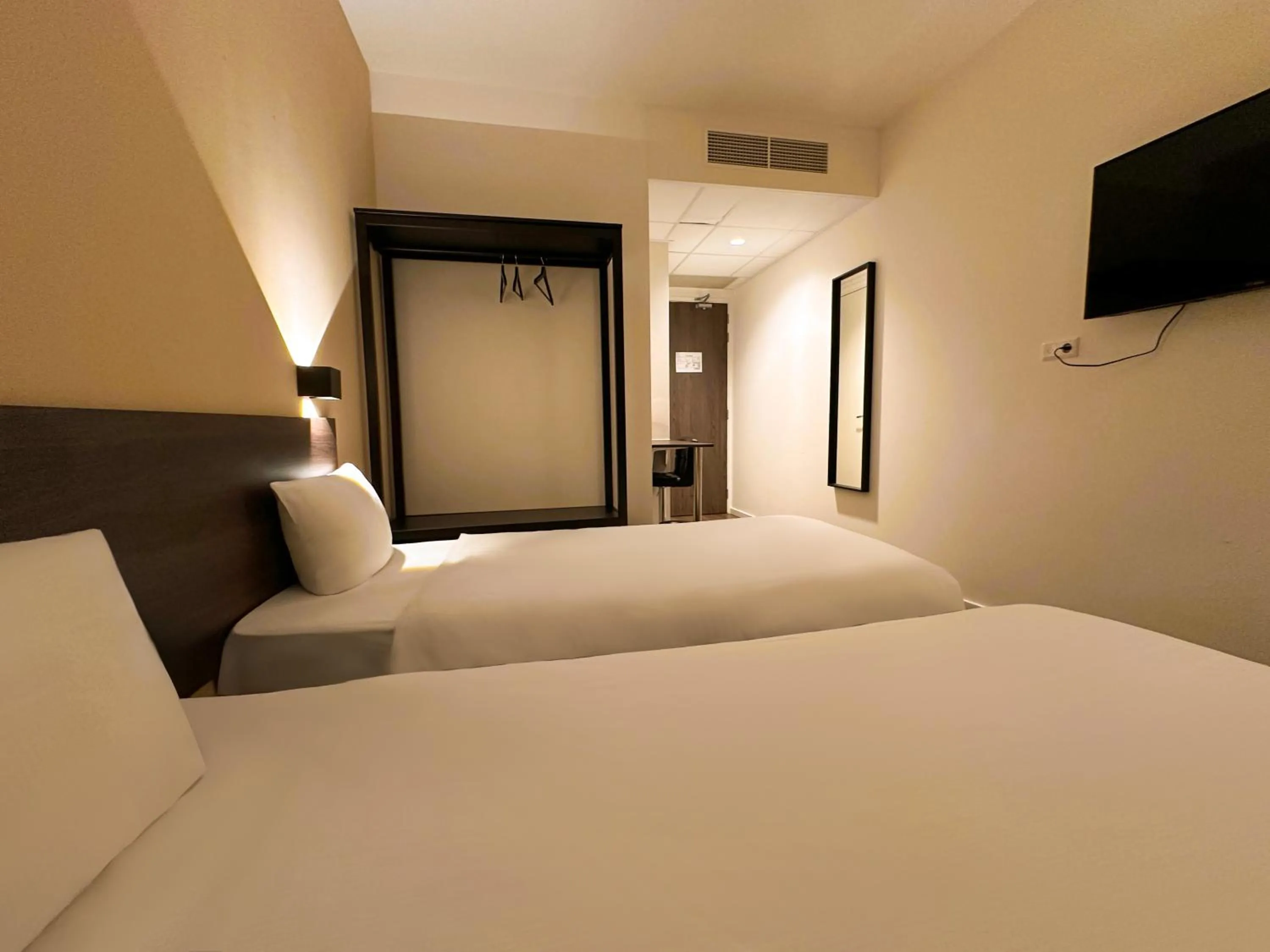 Bed in HOTELUX Amsterdam Airport Hotel