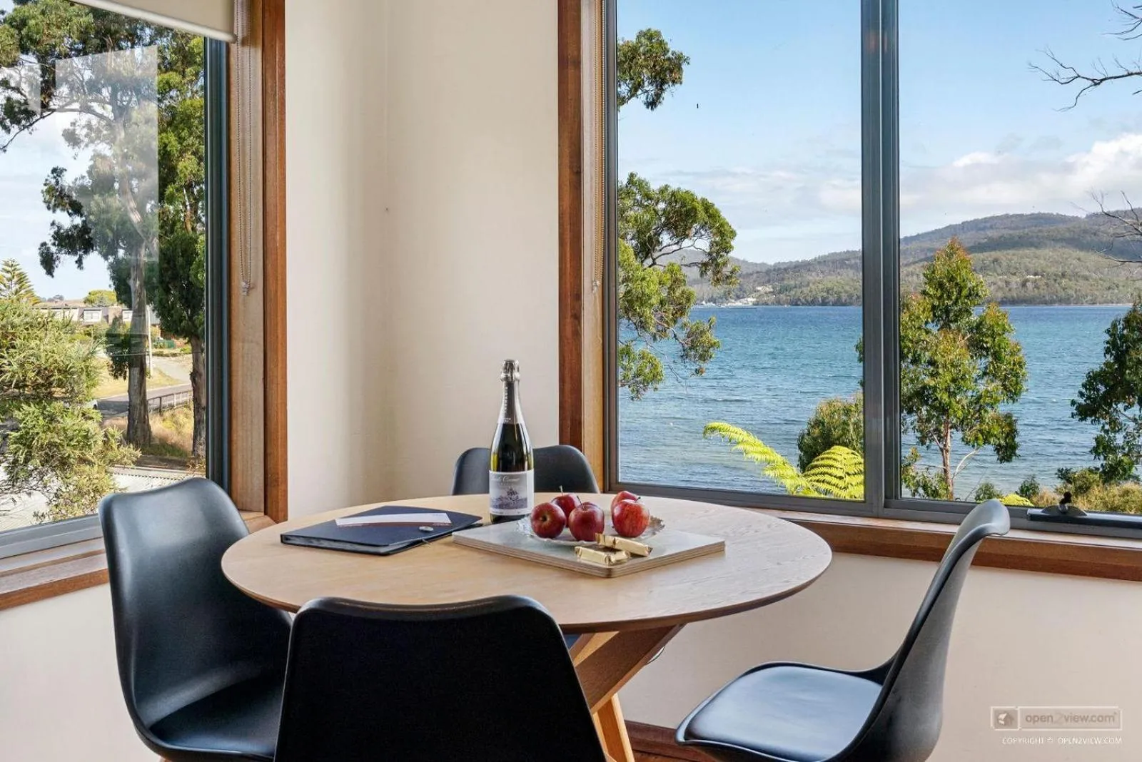 Dining area in The Beach House- private jacuzzi and wood fire!