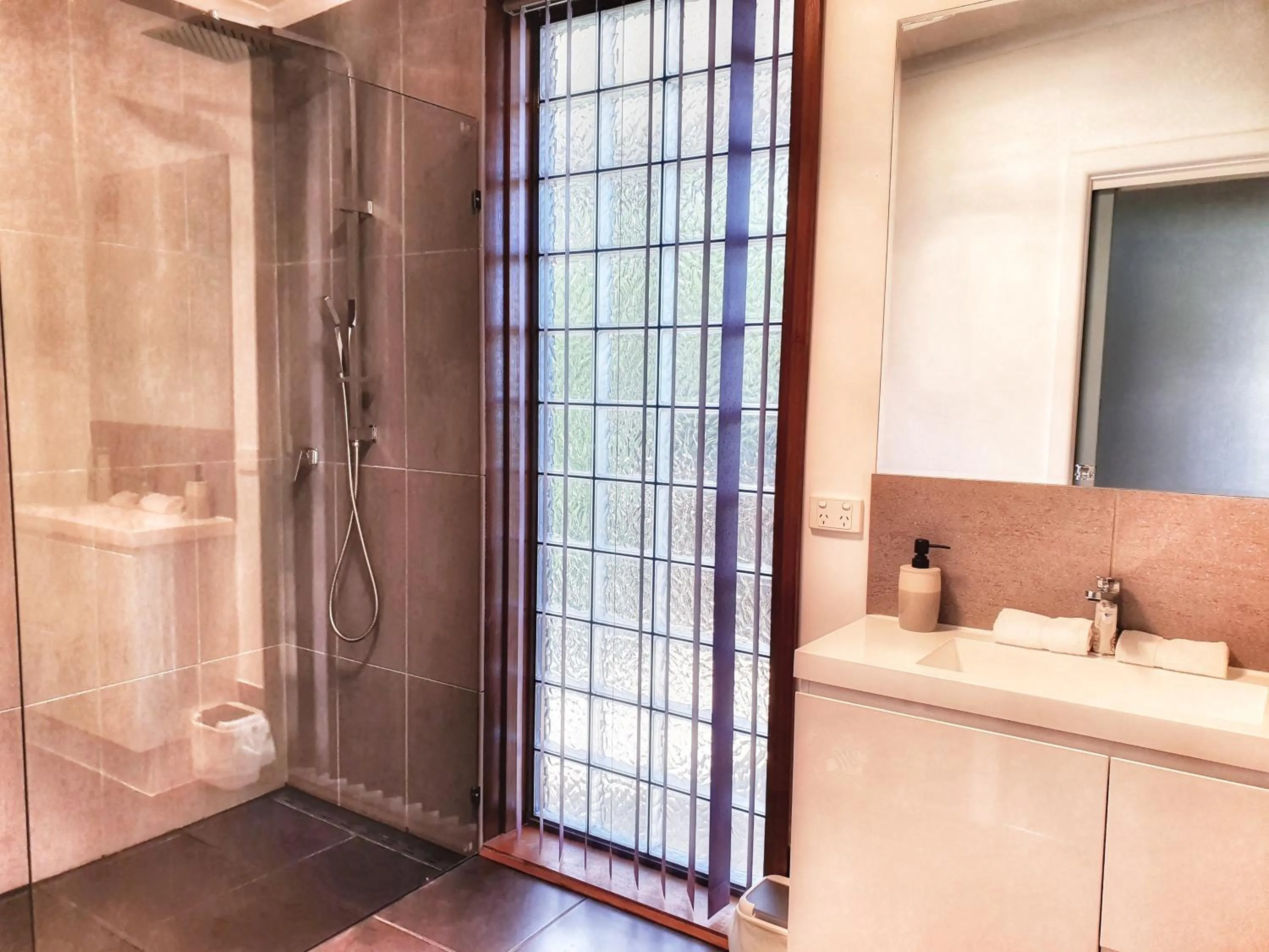 Bathroom in The Beach House- private jacuzzi and wood fire!