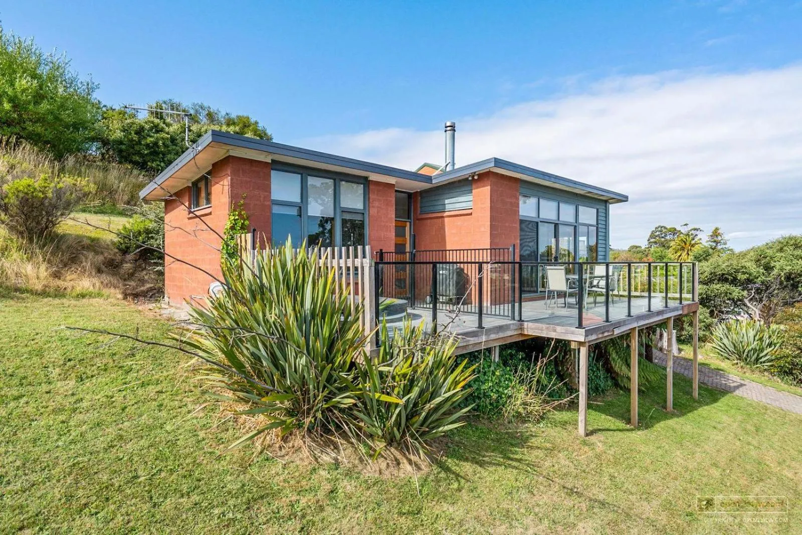 Property building in The Beach House- private jacuzzi and wood fire!