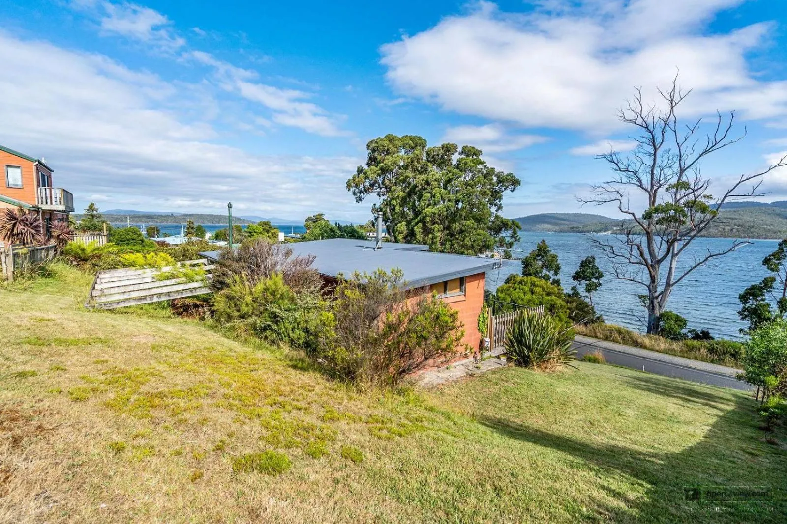 Property building in The Beach House- private jacuzzi and wood fire!