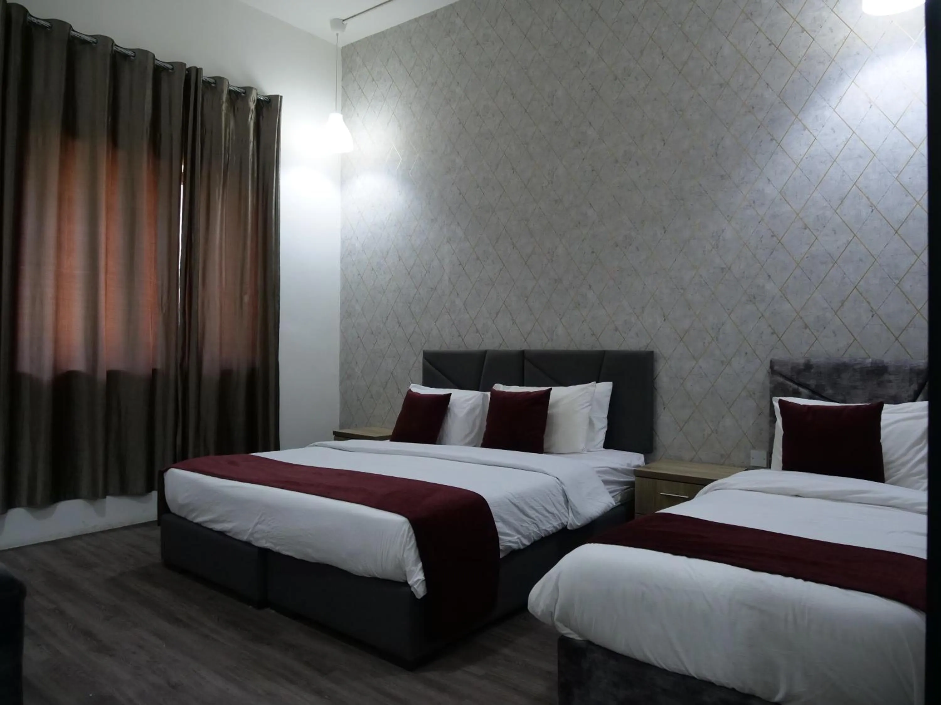 Bed in Twins Downtown Hotel