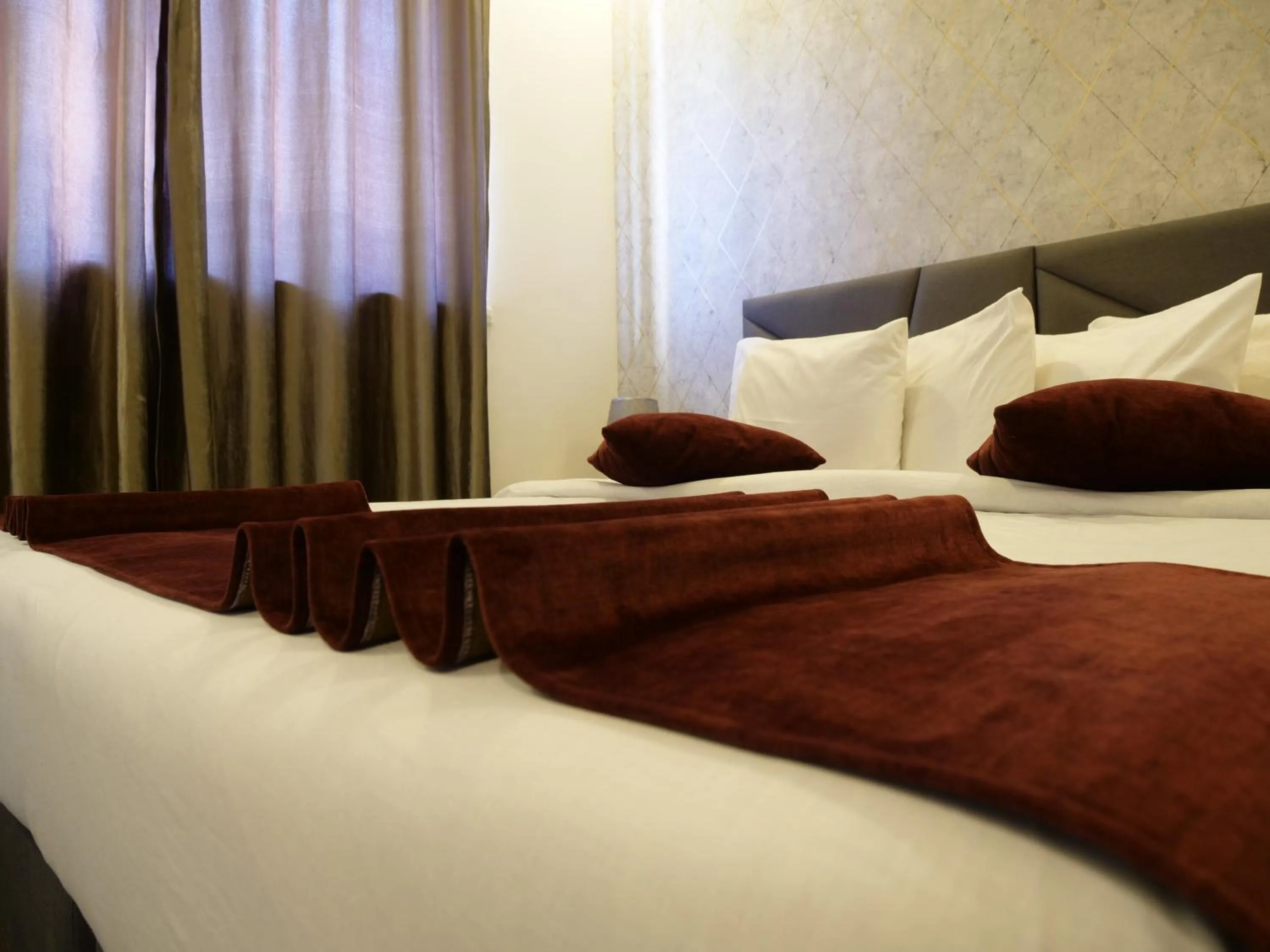 Bed in Twins Downtown Hotel