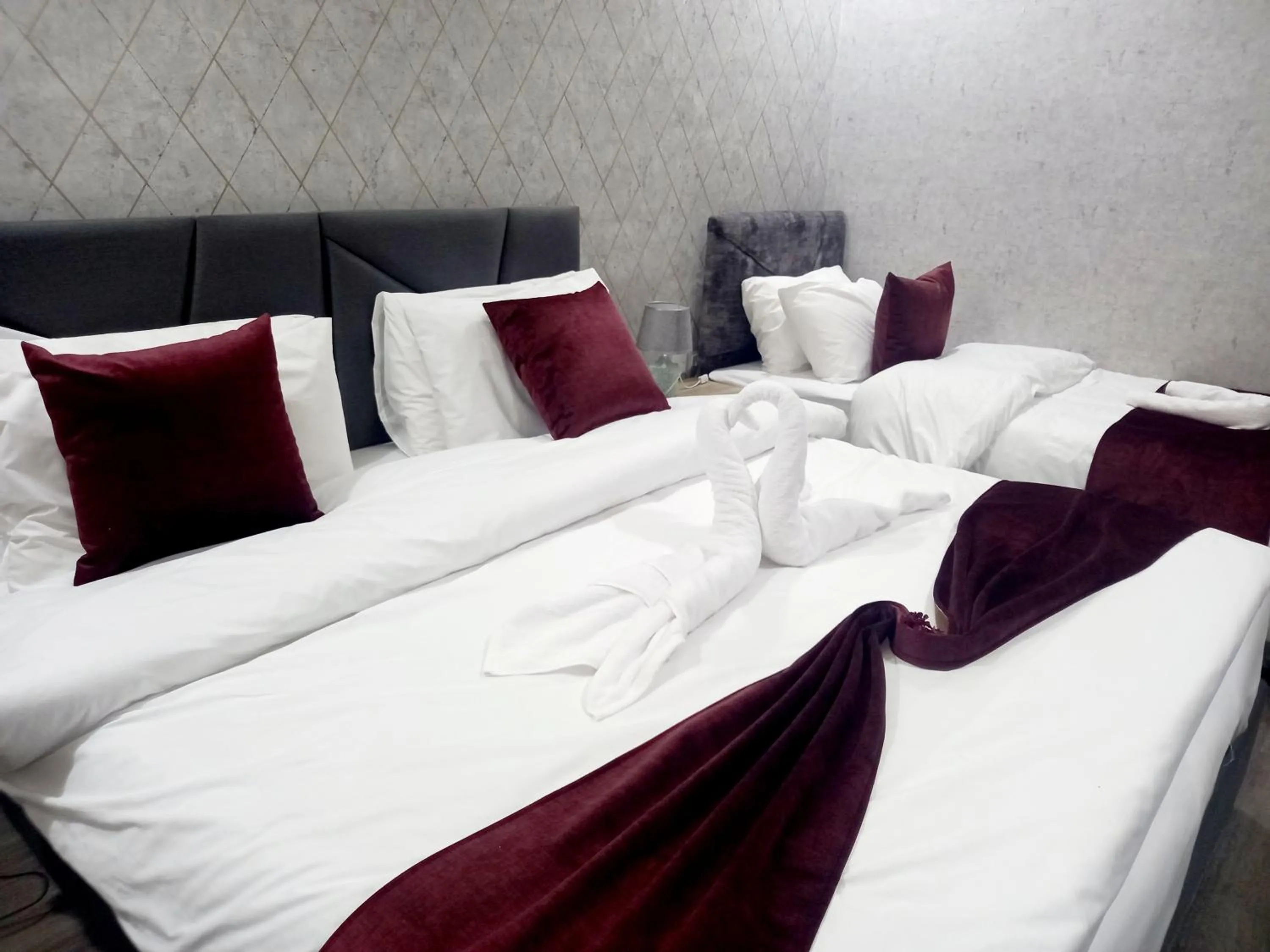 Bed in Twins Downtown Hotel