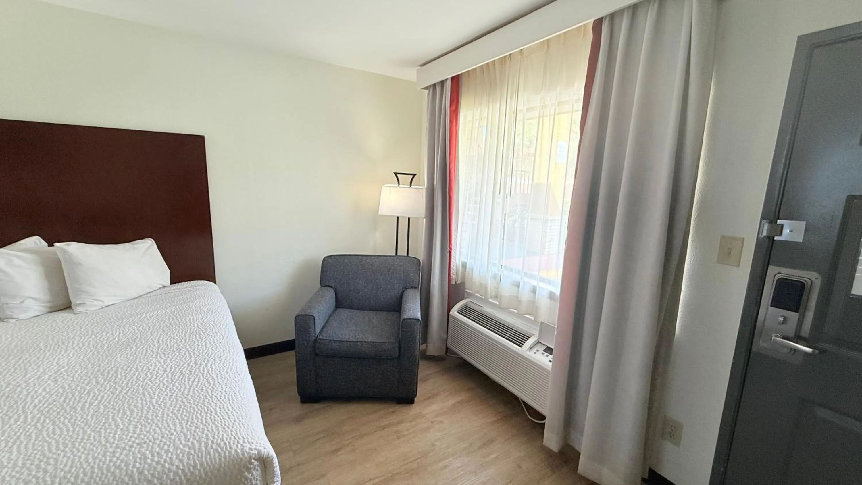 Seating area, Bed in Ramada by Wyndham San Antonio Near SeaWorld - Lackland AFB