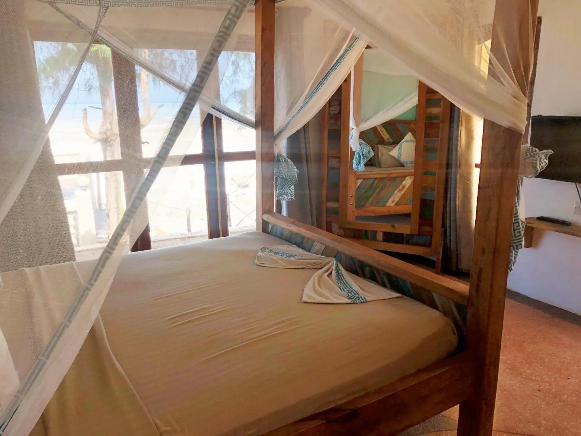 Bed in Reef & Beach Resort - Spa Jambiani Bed in Reef & Beach Resort - Spa Jambiani