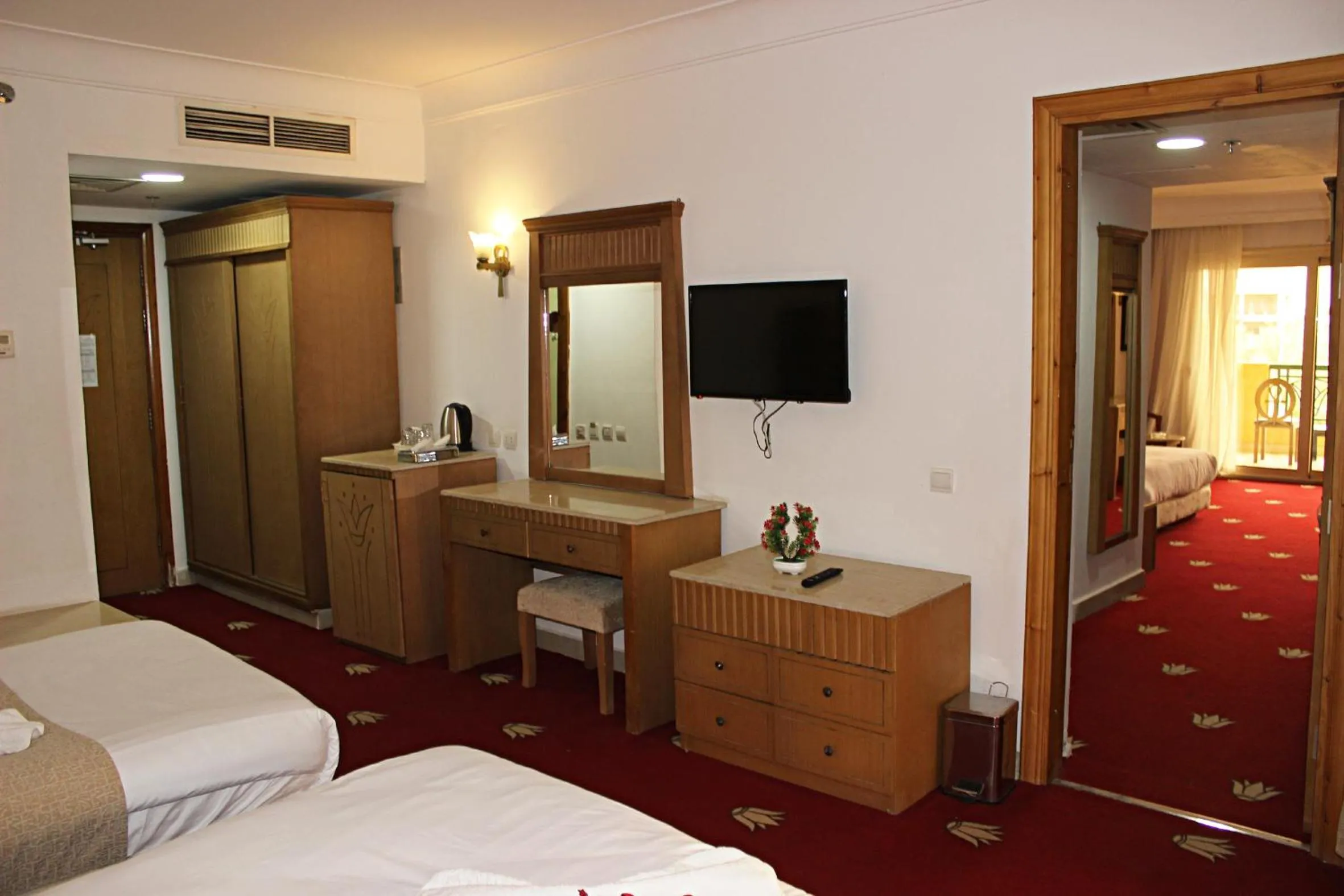 Communal lounge/ TV room, Bed in Regency Pyramids Hotel