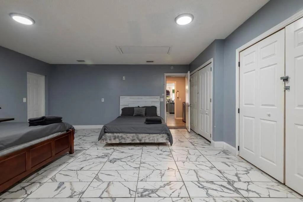 Bed in Tropical Escape with Relaxing Heated Pool & Palm Breezes