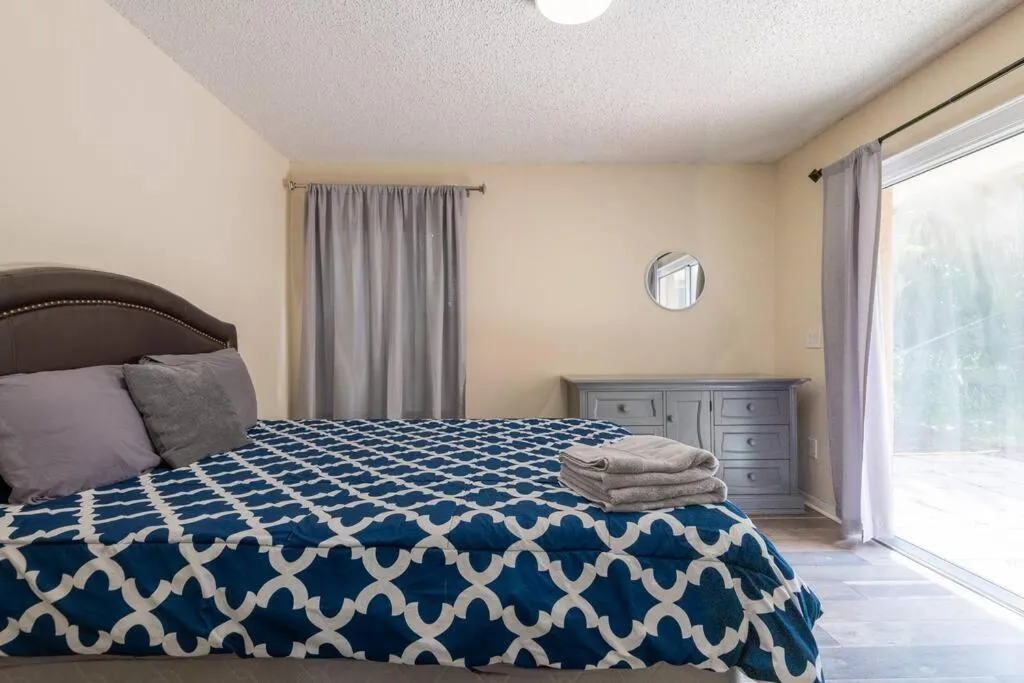 Bed in Tropical Escape with Relaxing Heated Pool & Palm Breezes