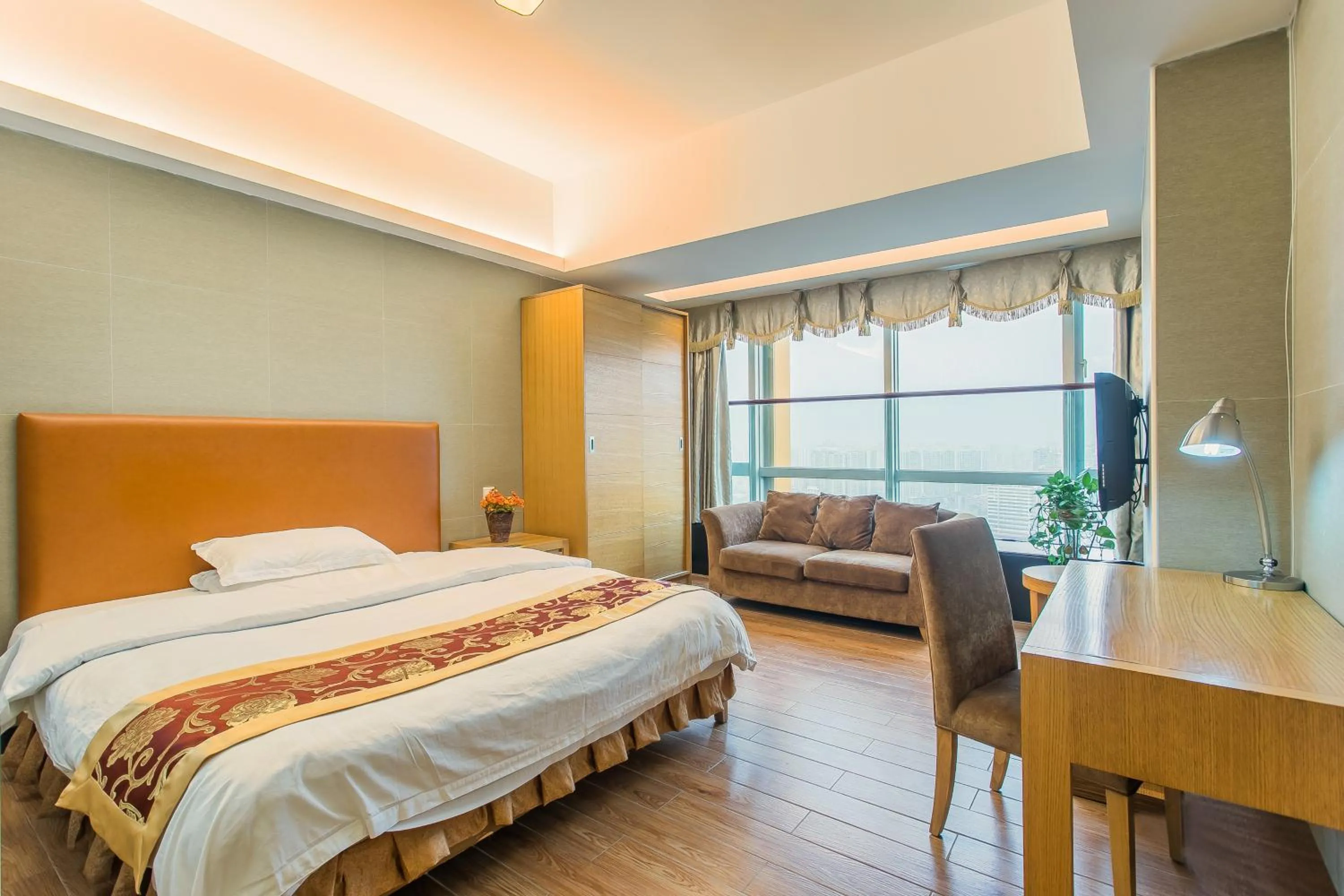 Bed in Grand Continental Apartment