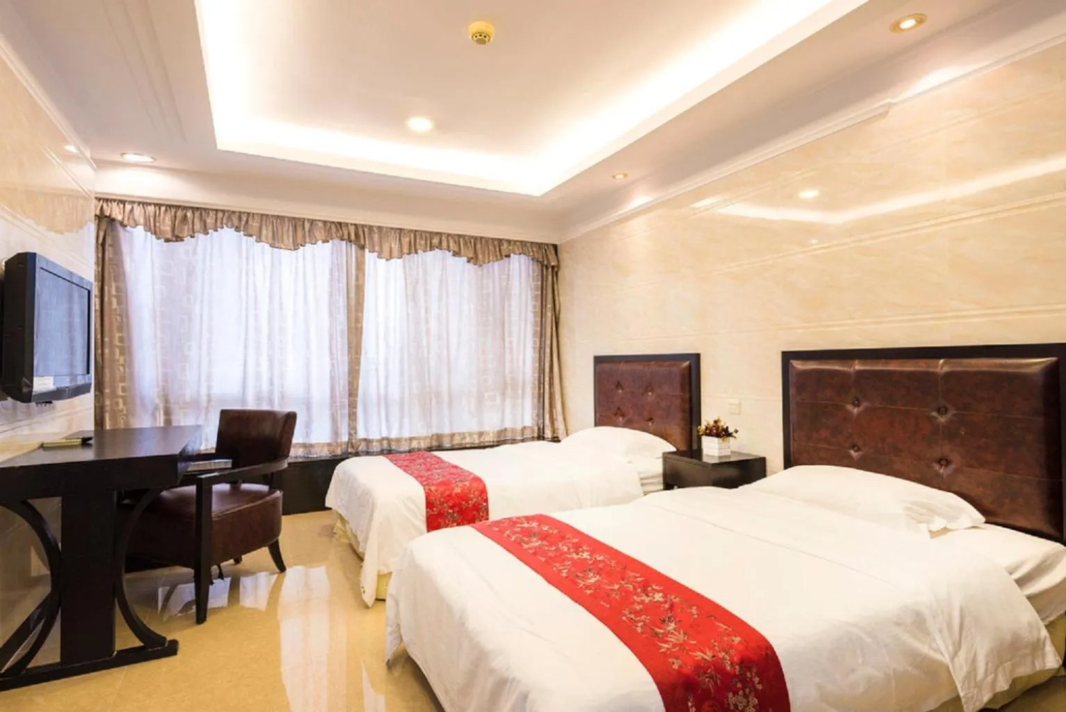 Bed in Grand Continental Apartment