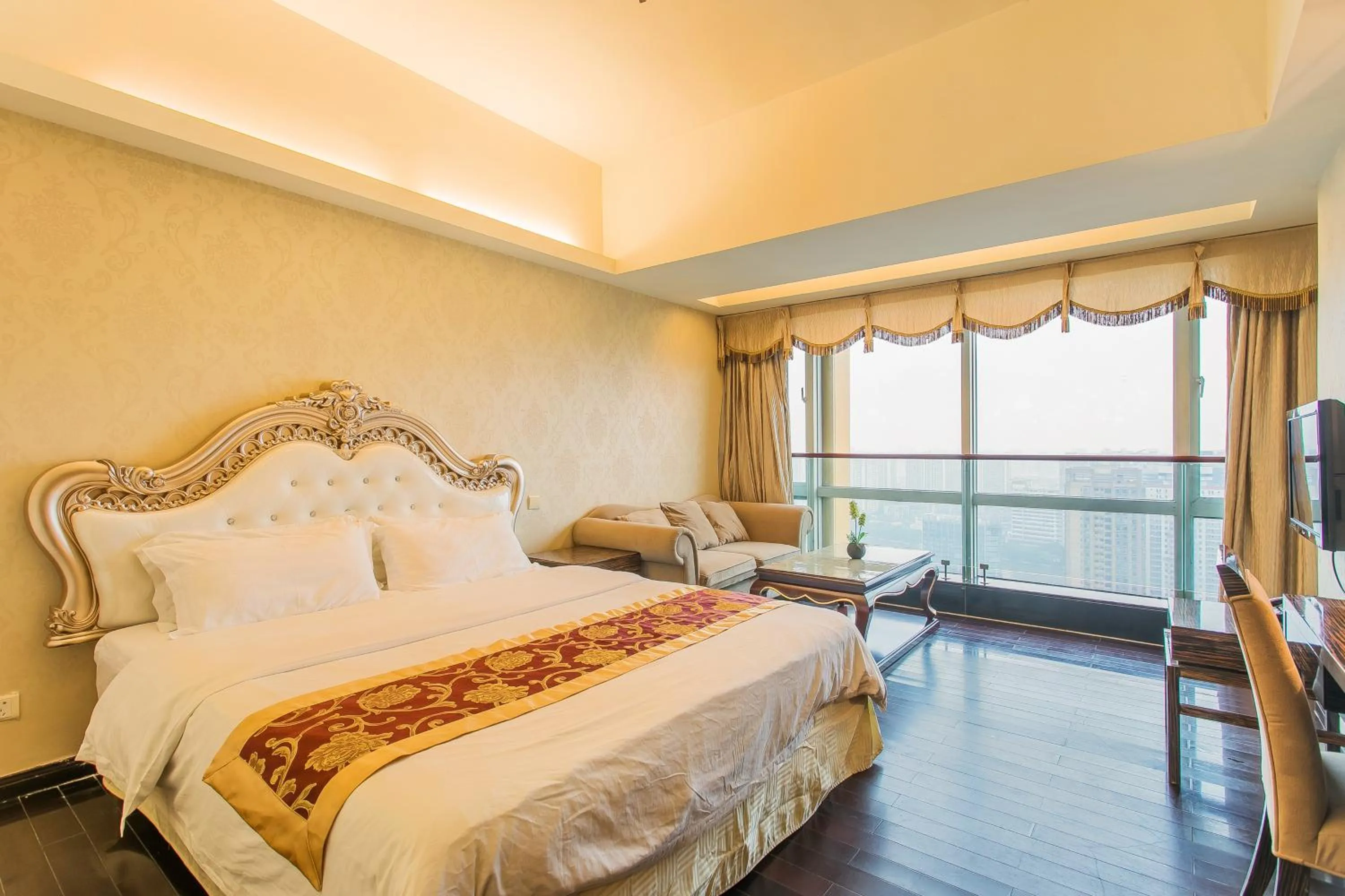 Bed in Grand Continental Apartment