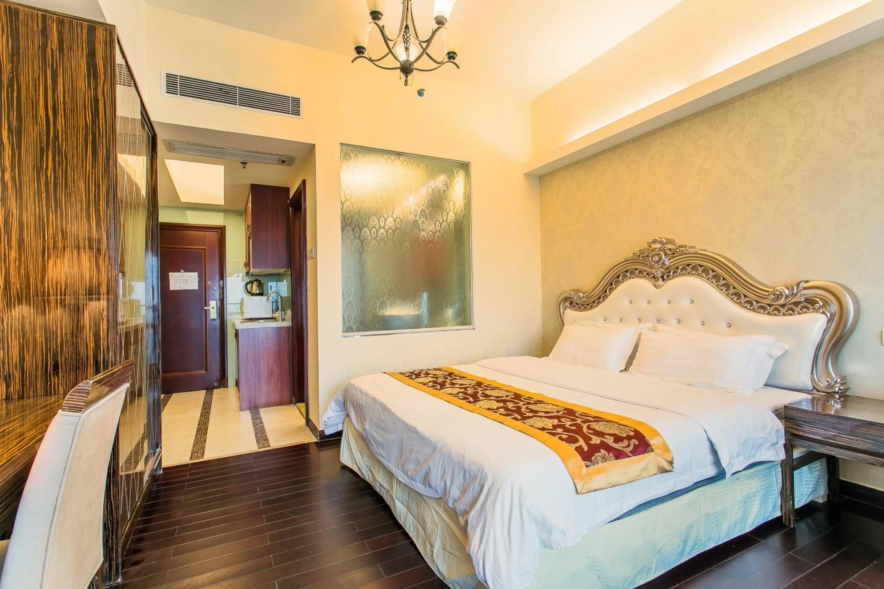 Bed in Grand Continental Apartment