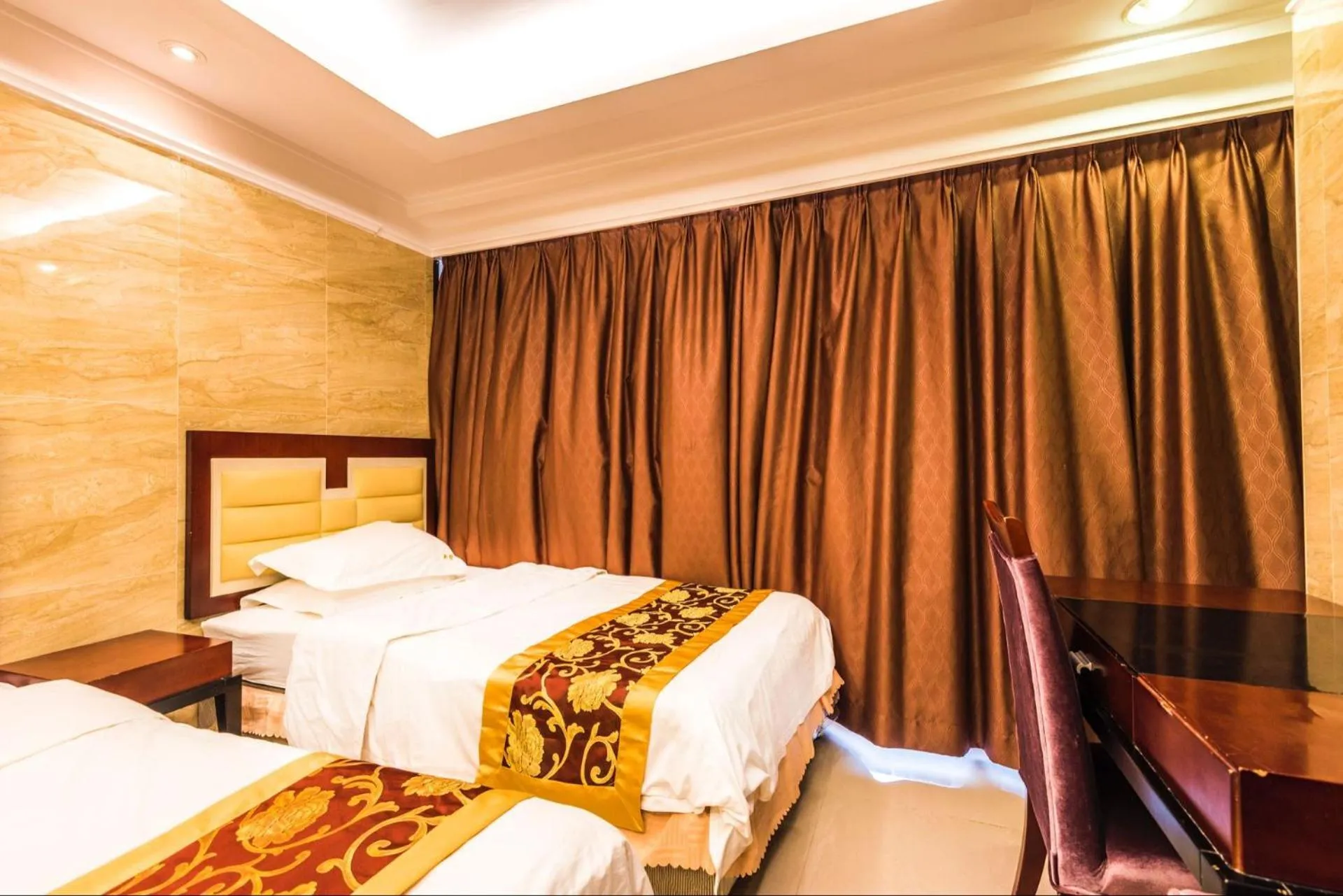 Bed in Grand Continental Apartment