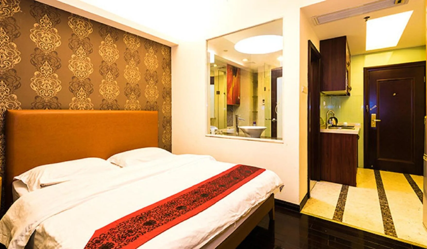 Bed in Grand Continental Apartment