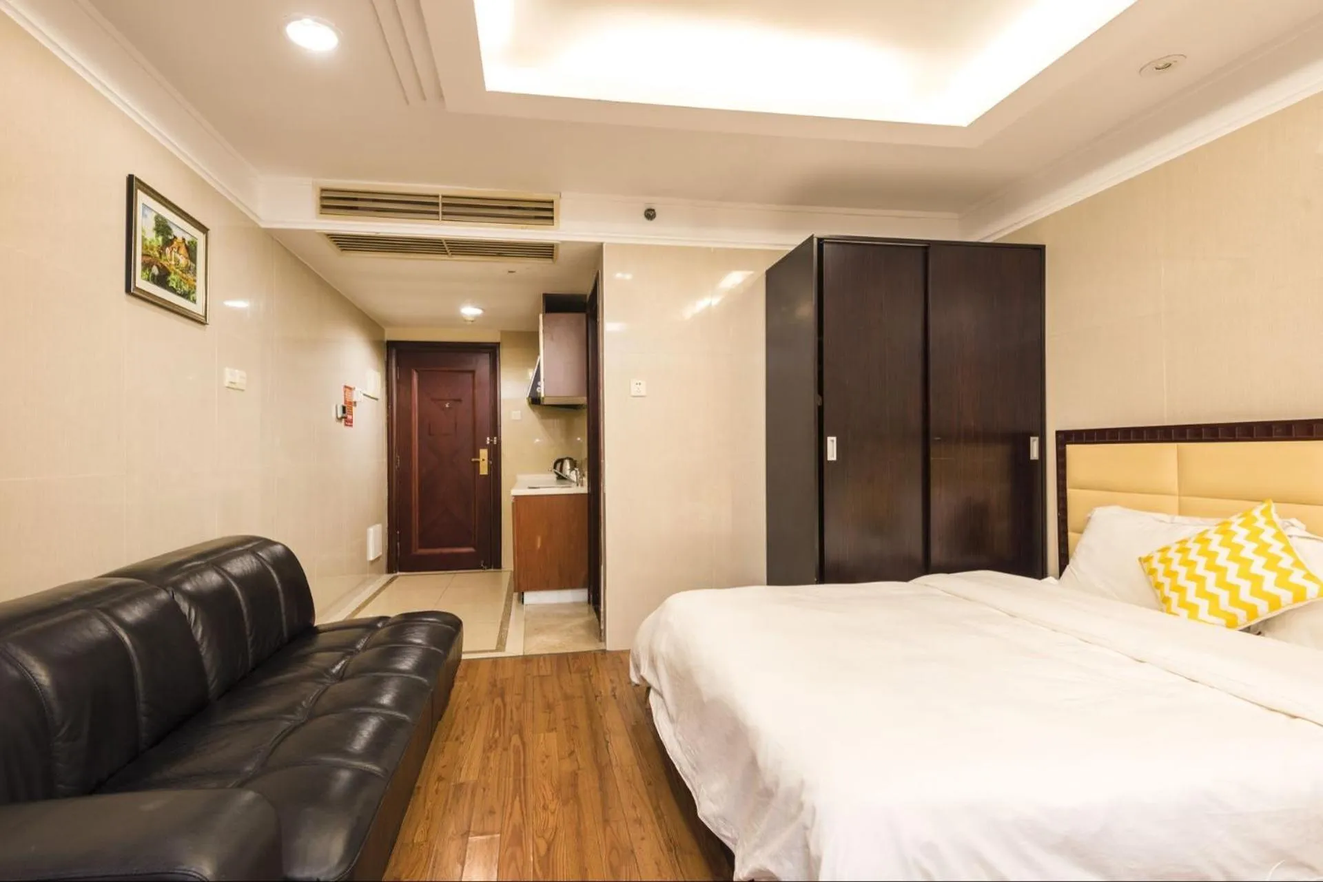 Bed in Grand Continental Apartment